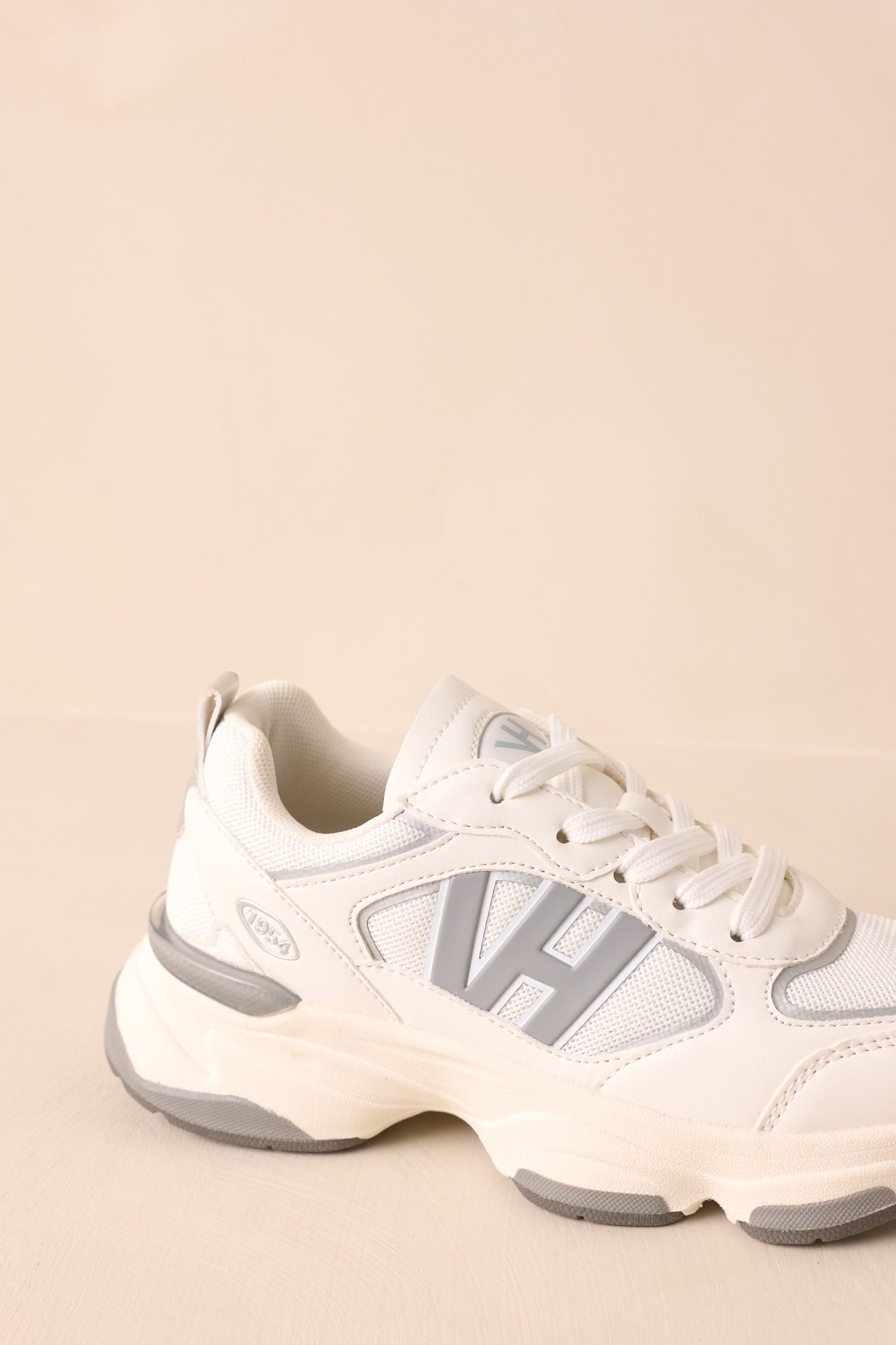 Close-up of front and midsection showing cushioned sole, lace-up closure, and grey accents.