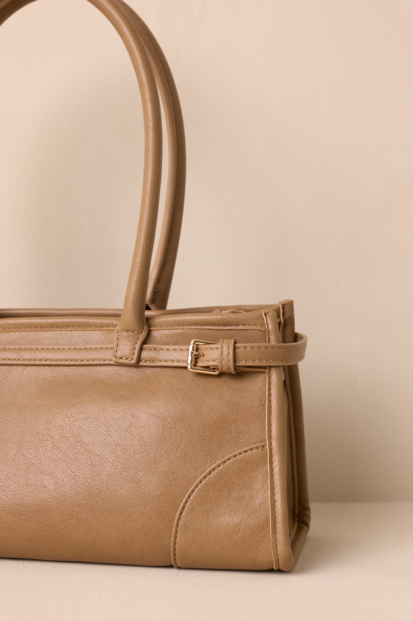 Close-up of the gold hardware, zipper pull, and interior pocket lining.