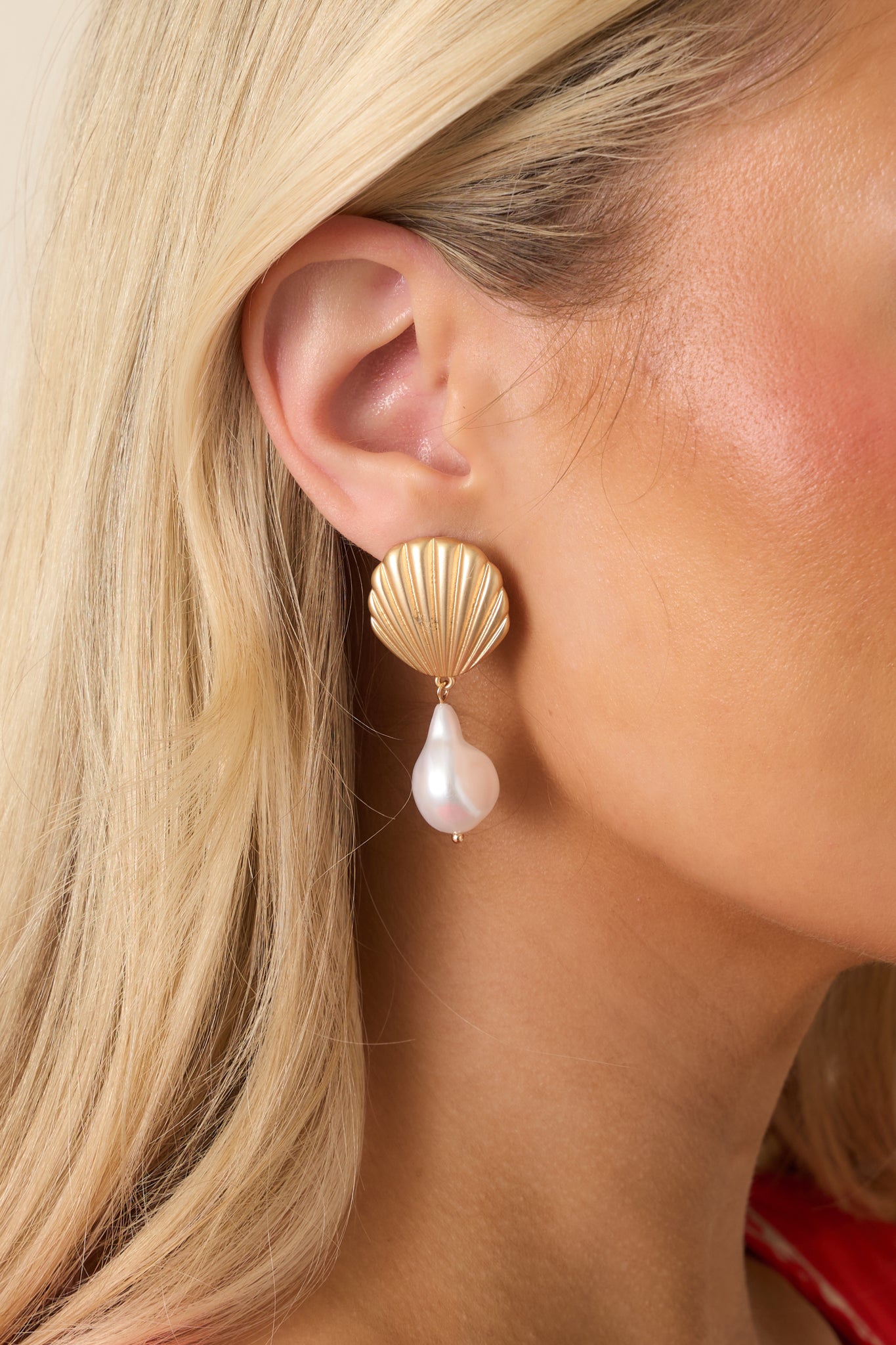 Close-up of the gold textured seashell studs, ivory pearl teardrops, and jump ring details.