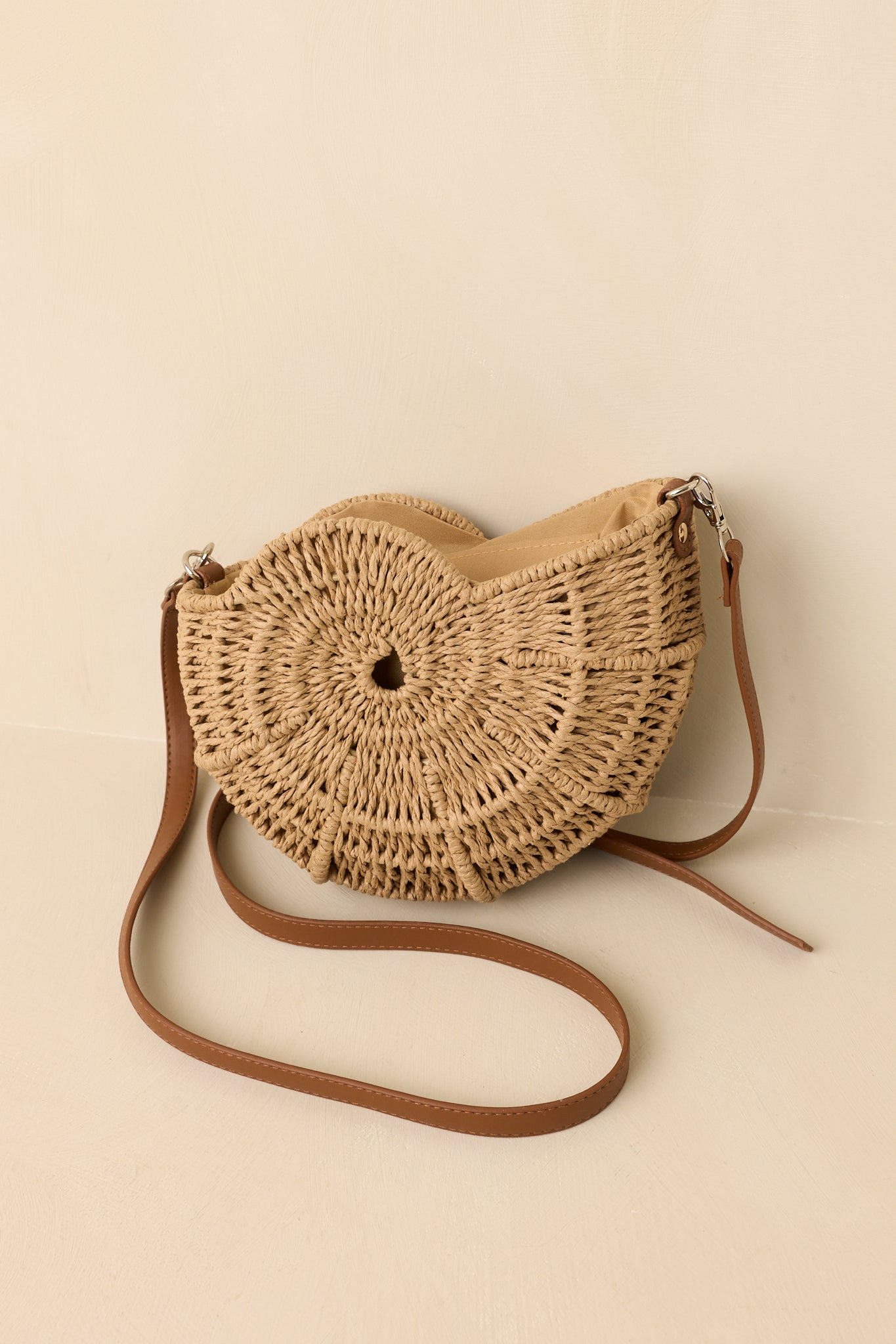 Close-up of the intricate woven spiral pattern, gold-tone hardware, and textured detailing on the handbag.