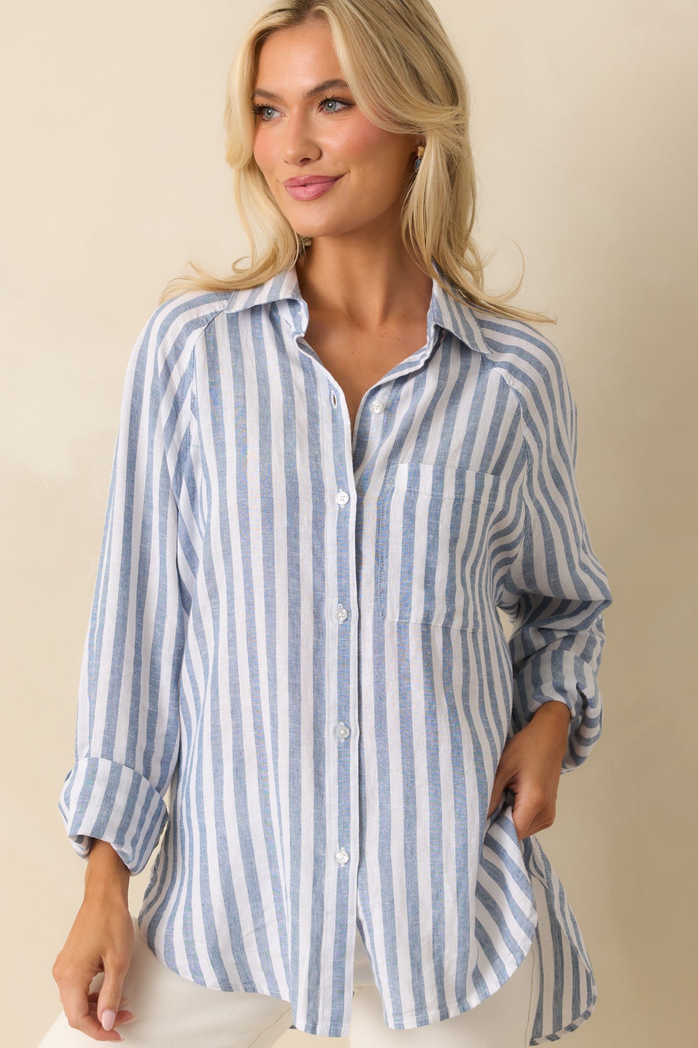 Close-up of the lower front of the top, highlighting the button-down closure and subtle stripe details on the fabric.
