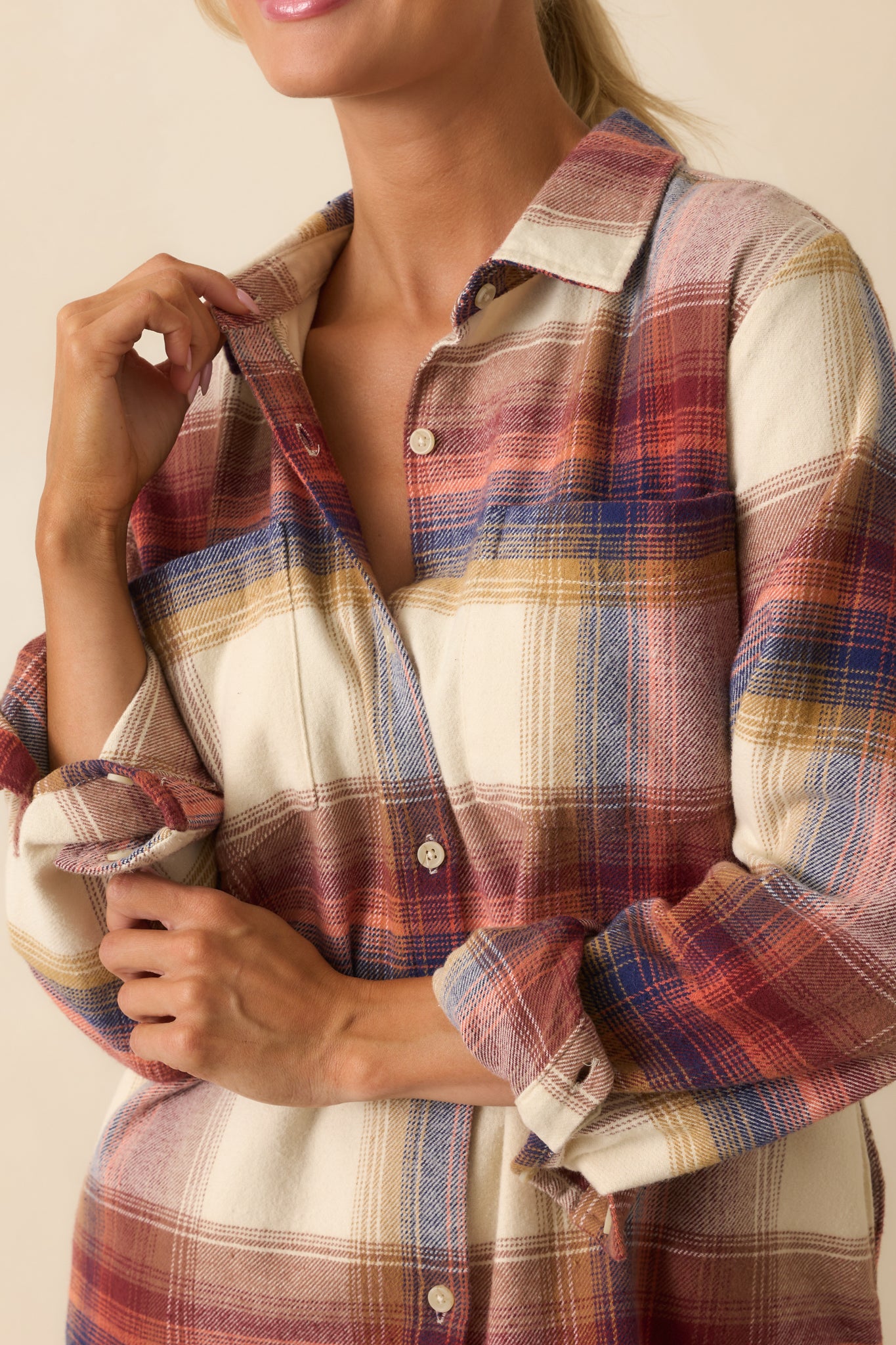 Close-up of ivory plaid flannel shirt showing textured fabric, plaid pattern, buttons, and collar detail.