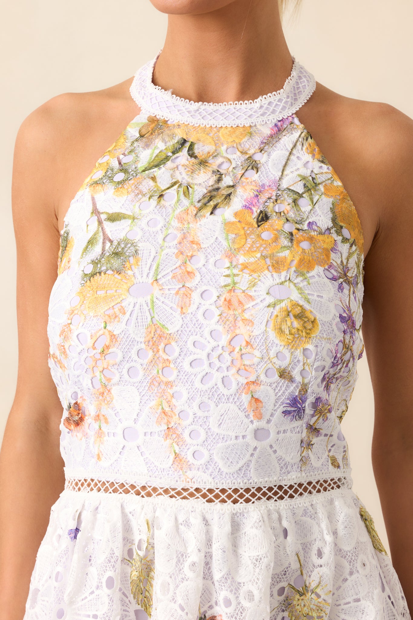 A closer look at the open ladder lace waist detail, showcasing the delicate embroidery and eyelet accents.