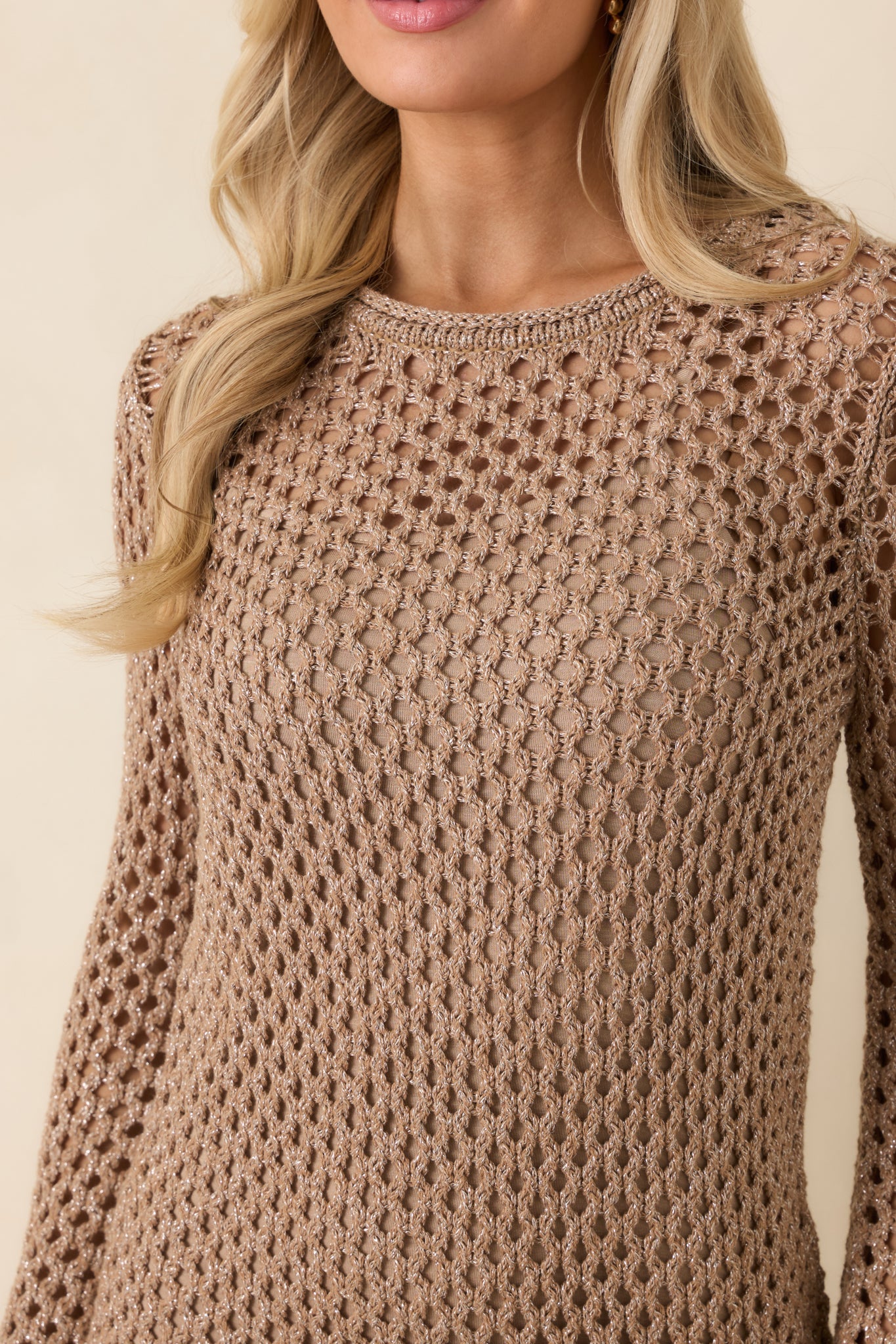 Close-up of mocha brown crochet fabric revealing open-knit construction, subtle shimmer, and ribbed edge detailing.