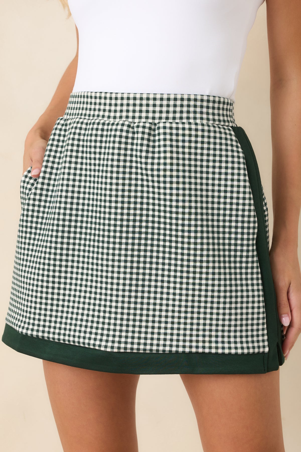 Close-up view of the gingham pattern, contrast trim, waistband, and tailored stitching details.