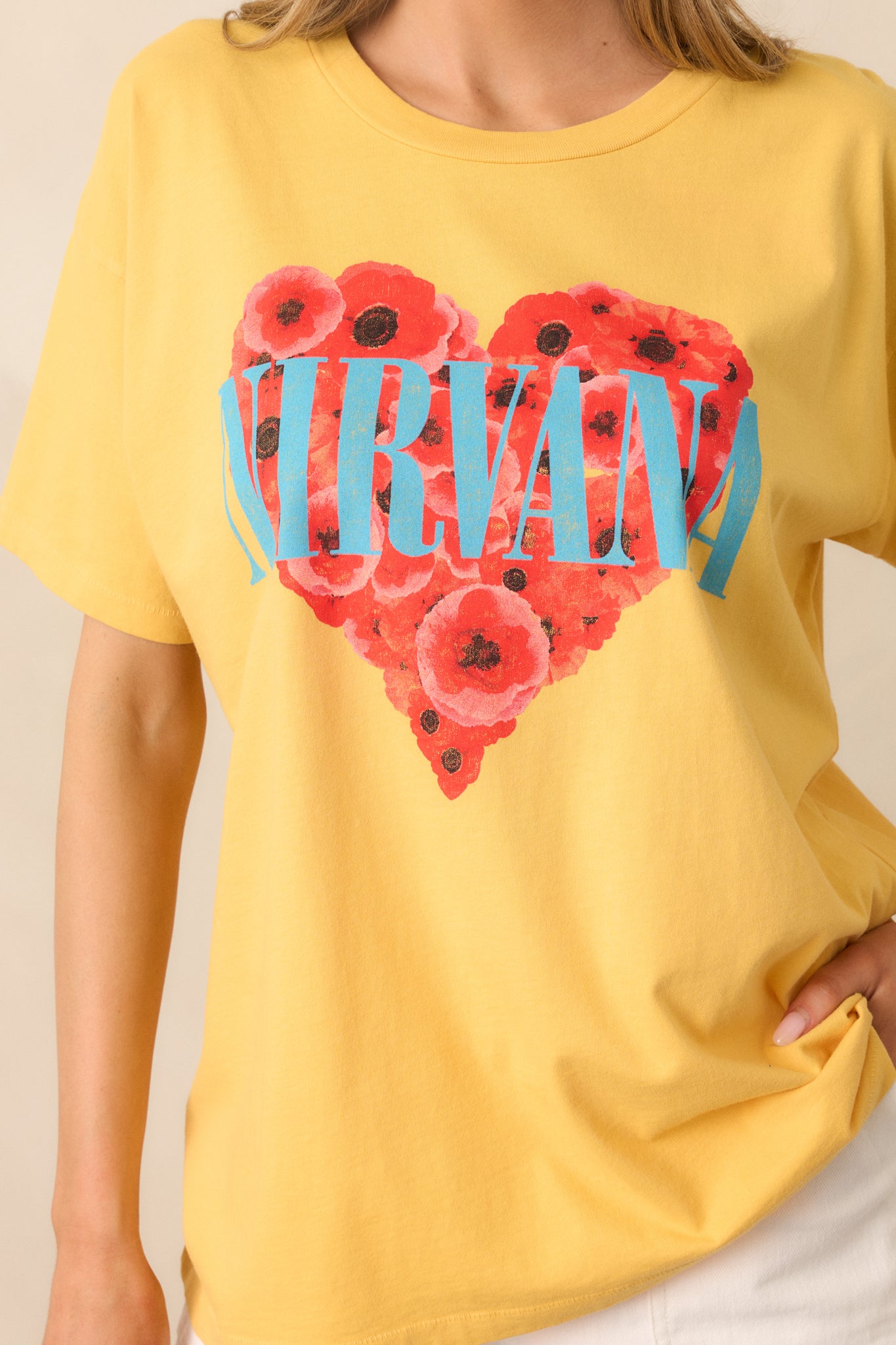 A close-up of the heart graphic filled with flowers, showcasing the colorful design and bold 'Nirvana' text.