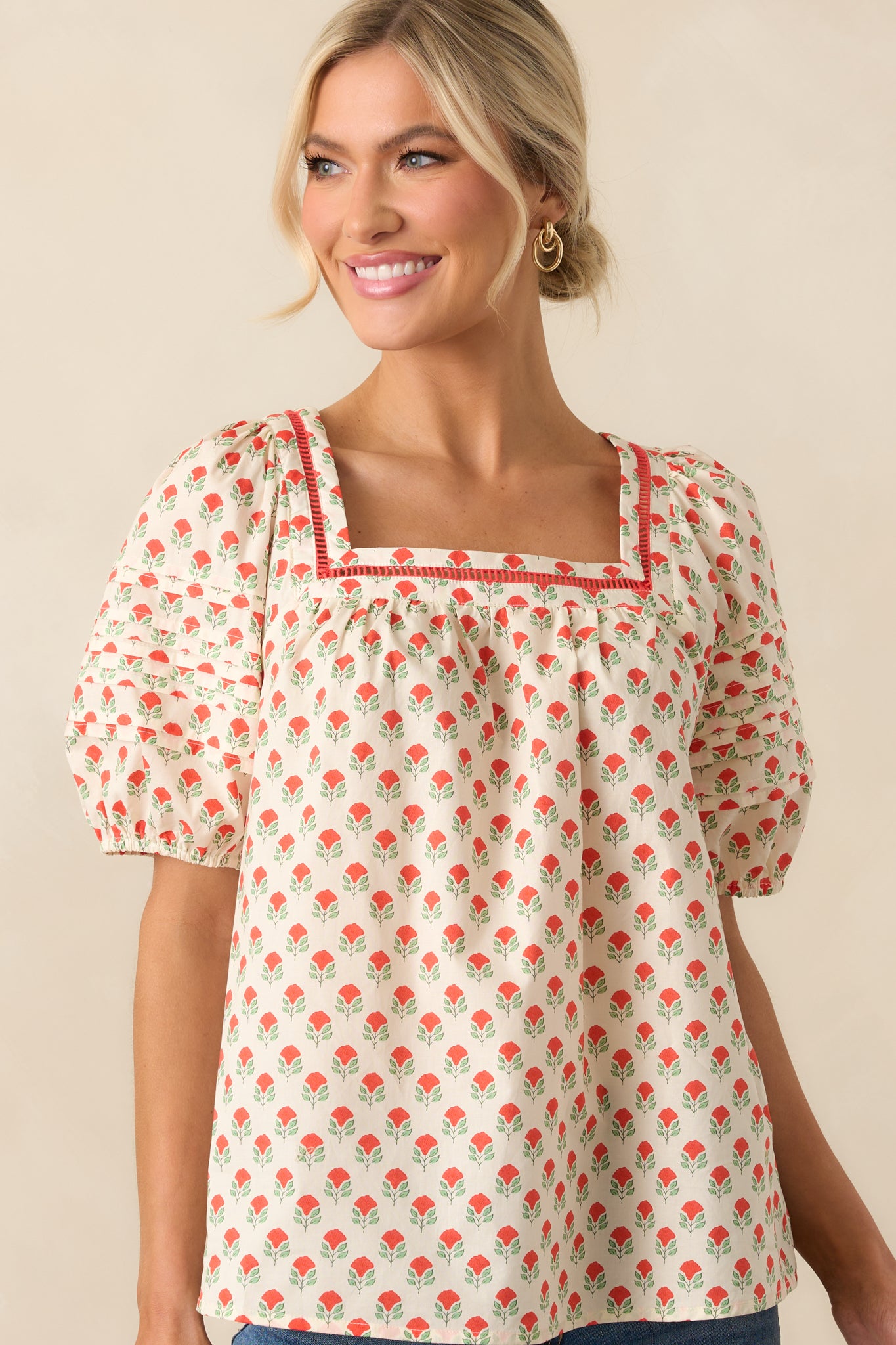 A close-up of the short puff sleeves with elastic cuffs, emphasizing the delicate floral print on the cotton fabric.