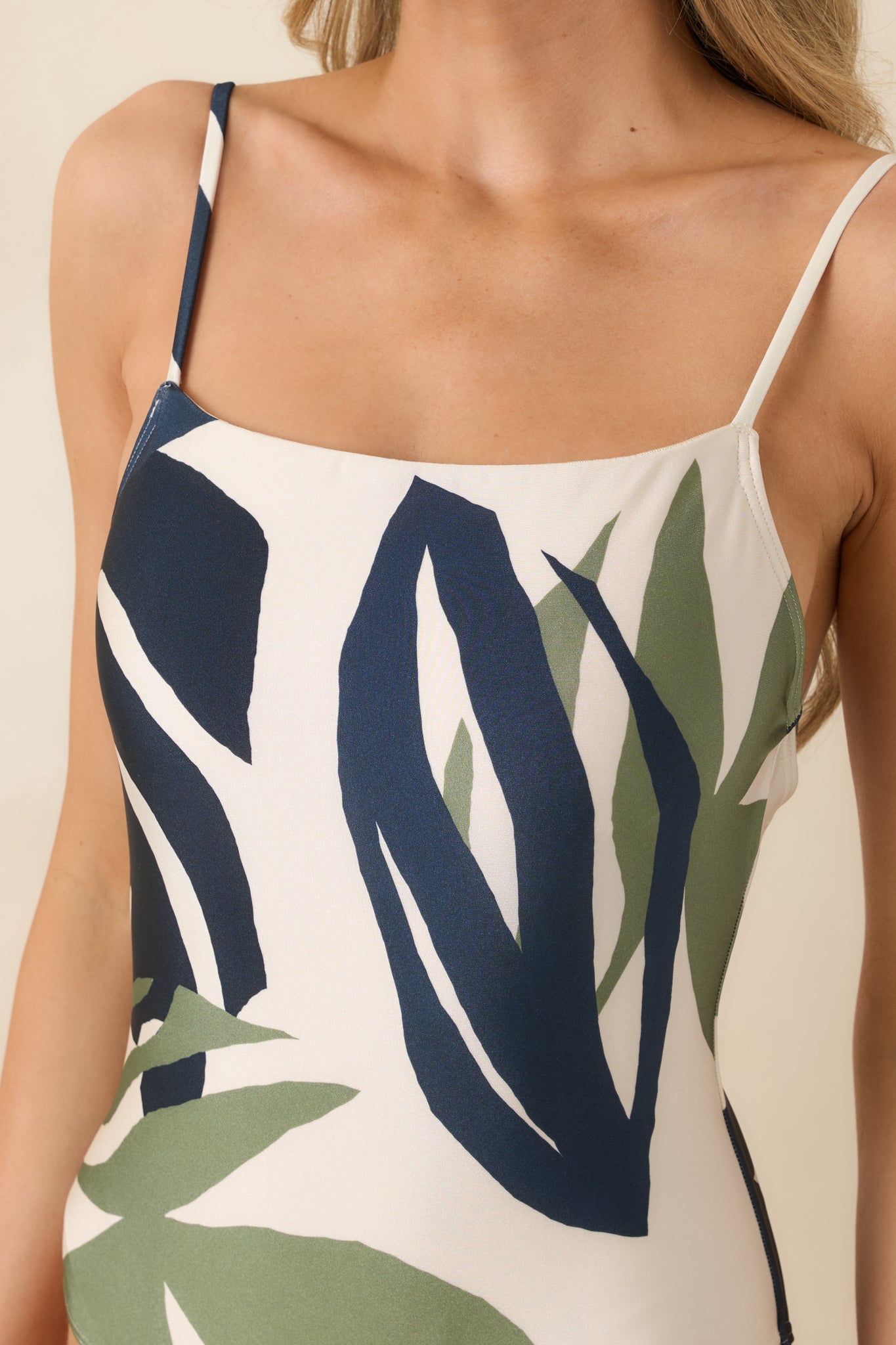 Close-up of the azure, soft green, and ivory palm leaf pattern showcasing the smooth, sleek fabric texture.
