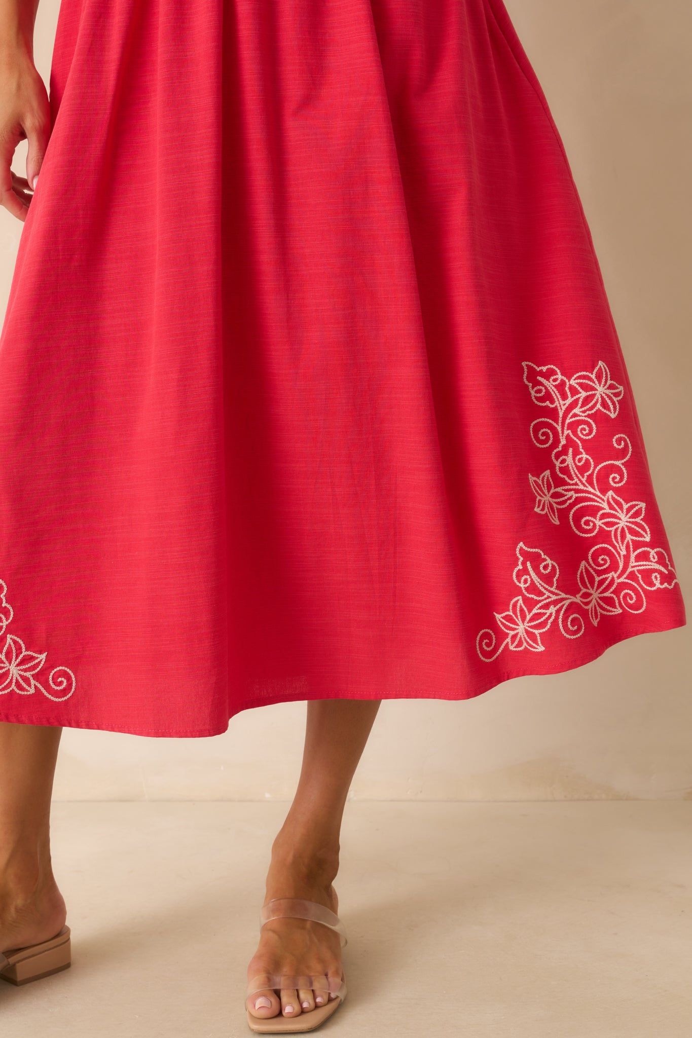 Close-up of the hemline showing the intricate design and lightweight fabric texture and finishing.