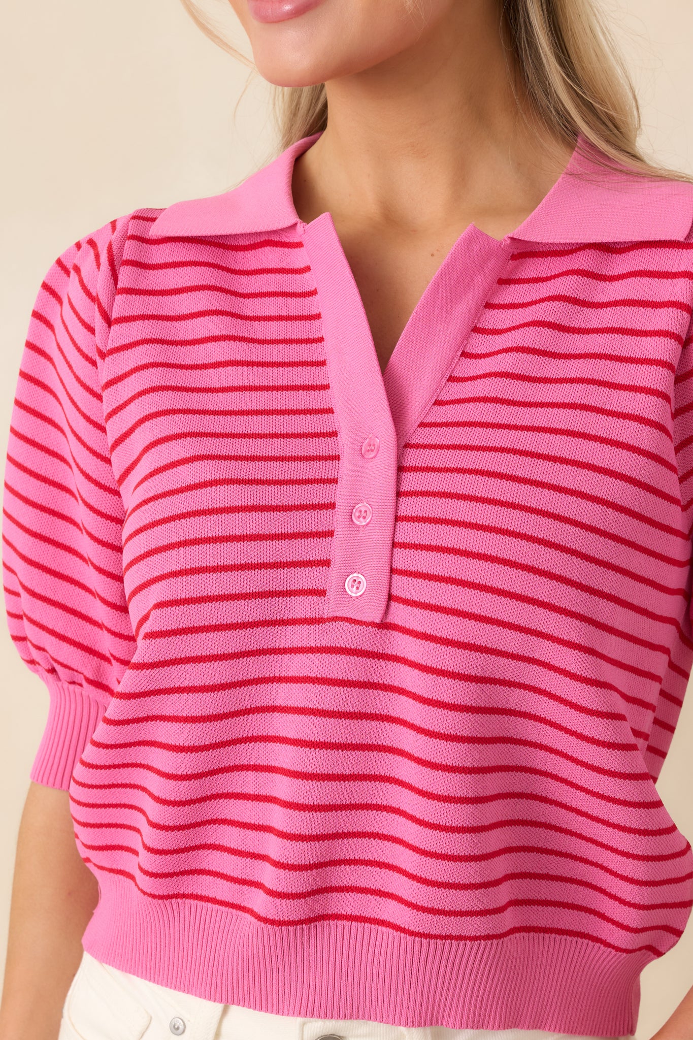 Close-up of the ribbed collar, cuffs, and hem, highlighting the knit texture and structured puff sleeve detail.