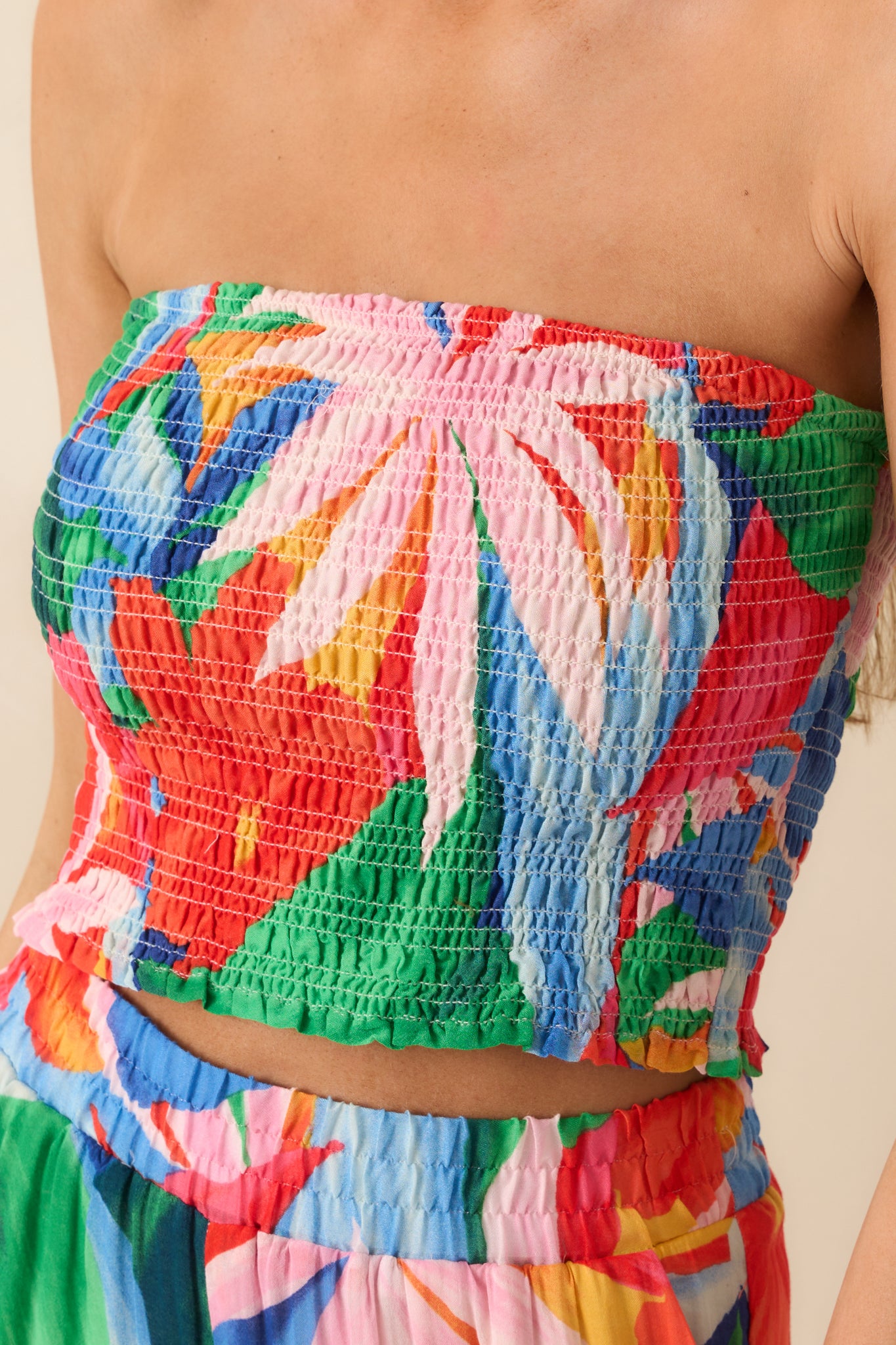 Close-up of the ruffled bottom hem, showing the stitching detail and layered effect of the floral print fabric.