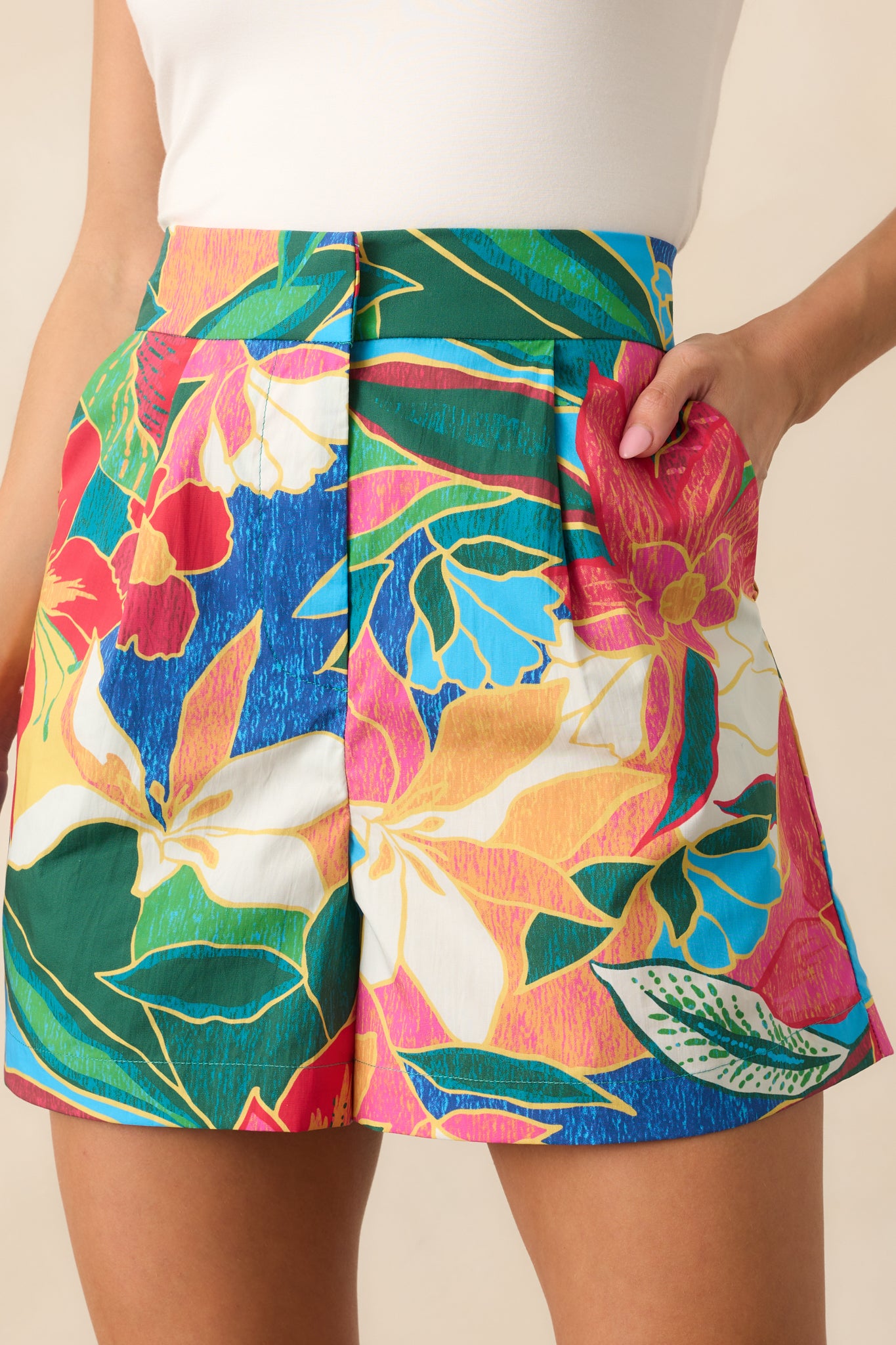 Close-up of the waistband and front zipper with hook and eye closure on the printed blue shorts.