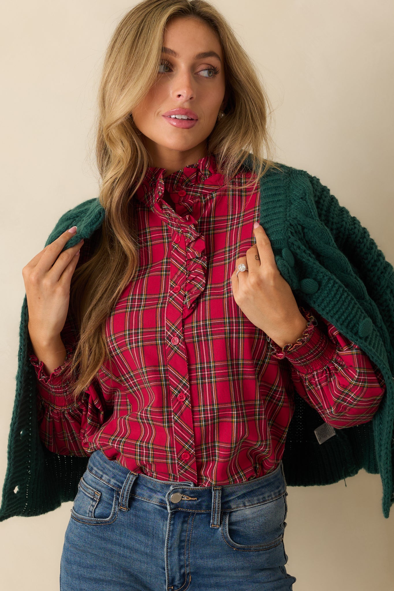 Close-up of the plaid fabric across the bodice highlighting the button-up front and ruffle neck detail.