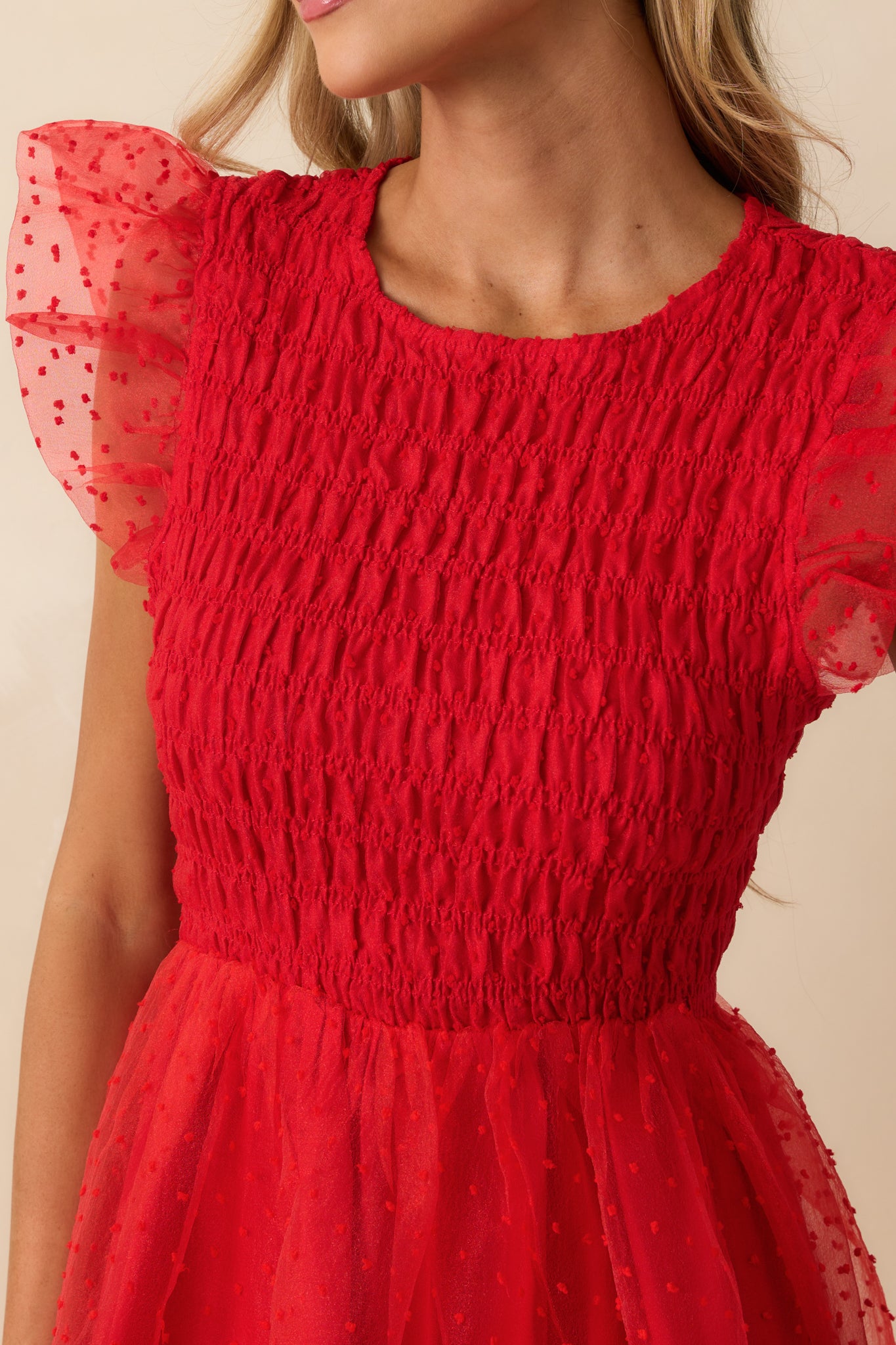Close-up of the smocked bodice and polka dot tulle overlay