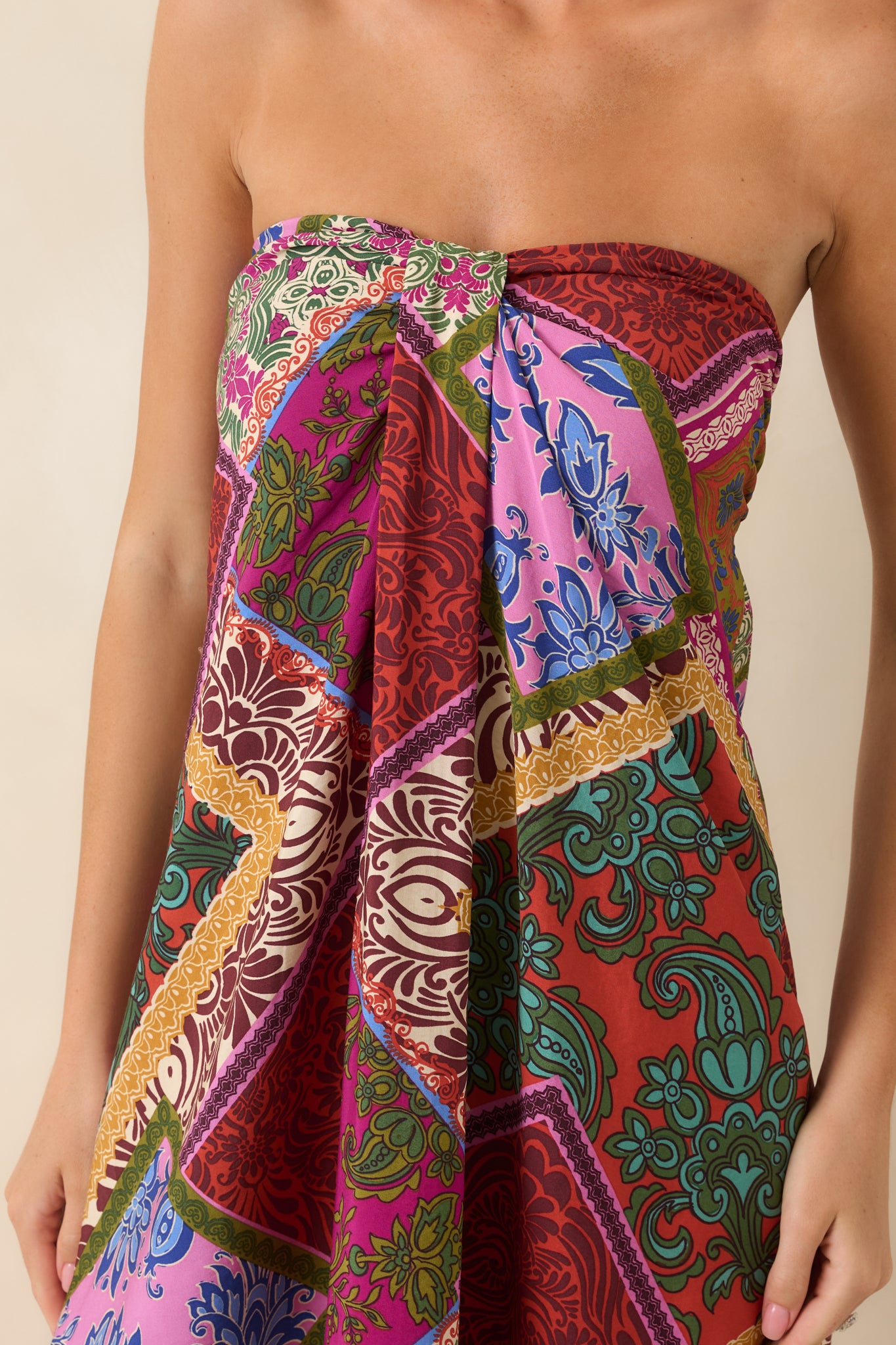 Close-up of the red multi patchwork midi dress highlighting the strapless neckline, silicone non-slip strip, and front box pleat detail.