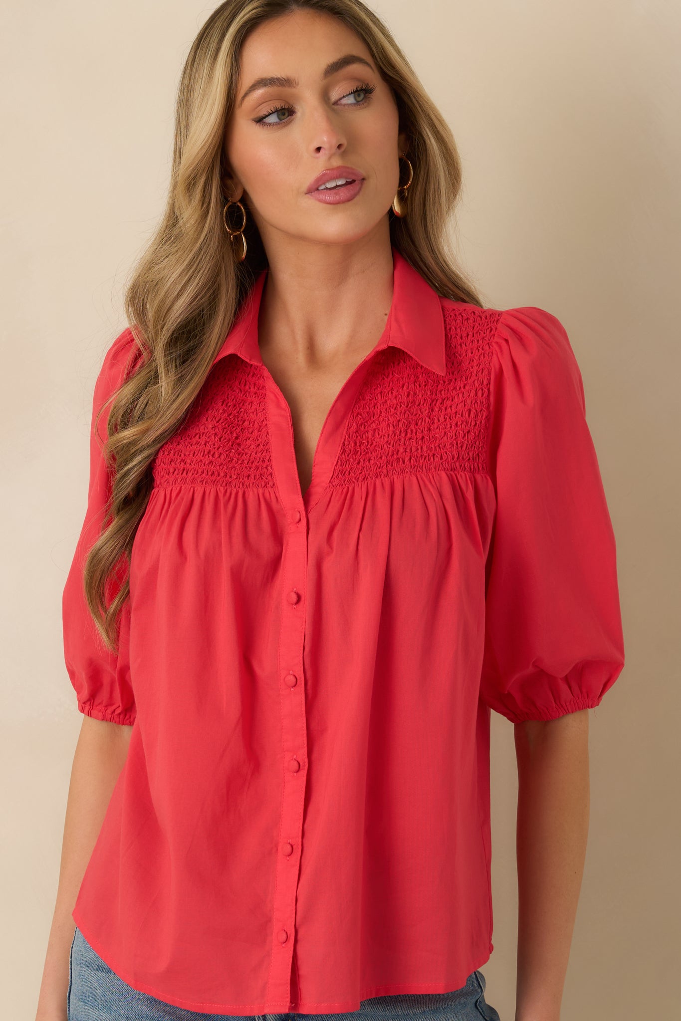Close view of the classic collar and button-up front on the watermelon red blouse.