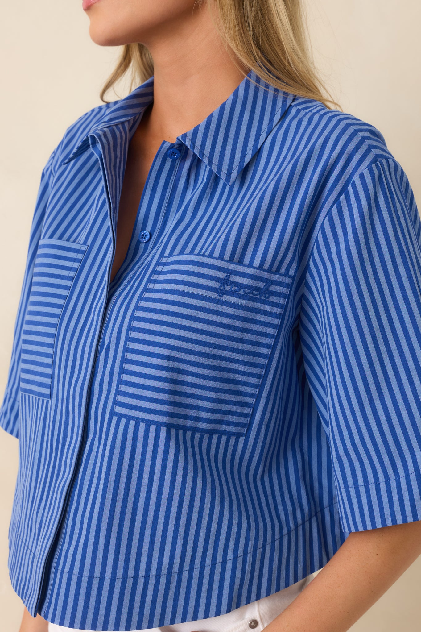 Close-up view of the collar, front patch pocket, and unique mixed-direction stripe pattern detailing.