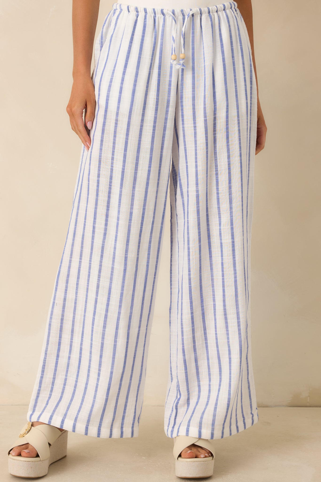 Close view of the blue stripe pattern and elastic waistband with adjustable drawstring tie.