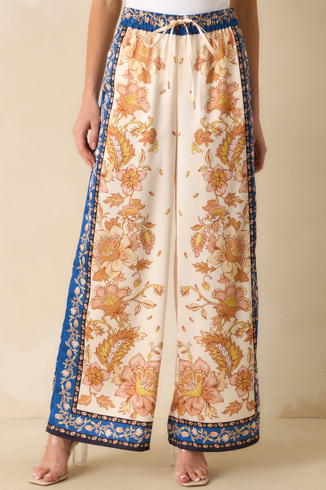 Close view of the elastic waistband with adjustable drawstring and scarf-style floral print.