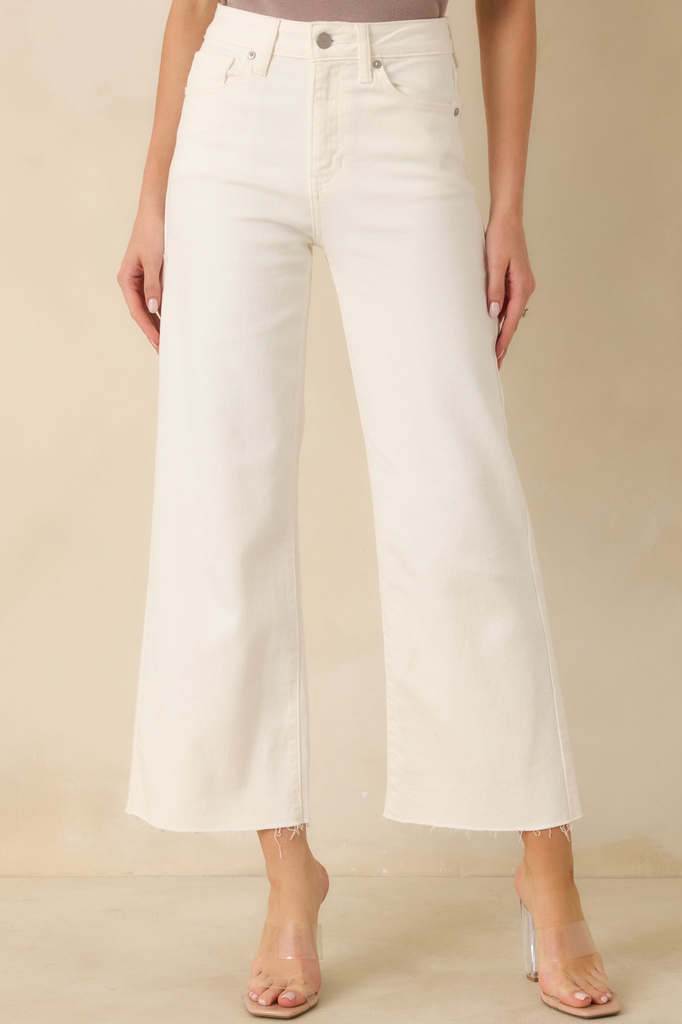 Close view of wide-leg silhouette and slightly cropped hem with raw edge finish.