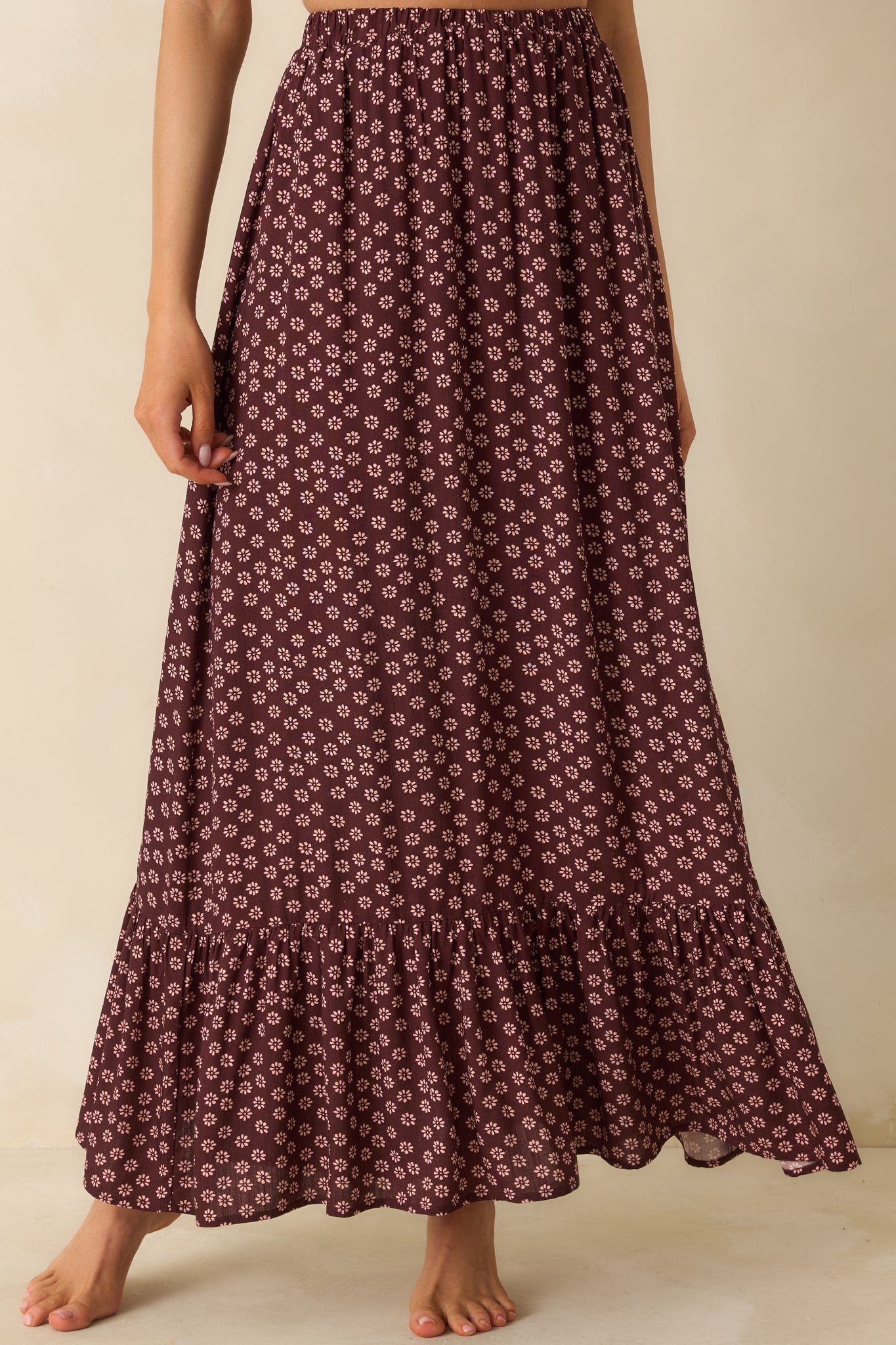 Close view of the skirt’s lightweight burgundy fabric with soft, fluid movement.