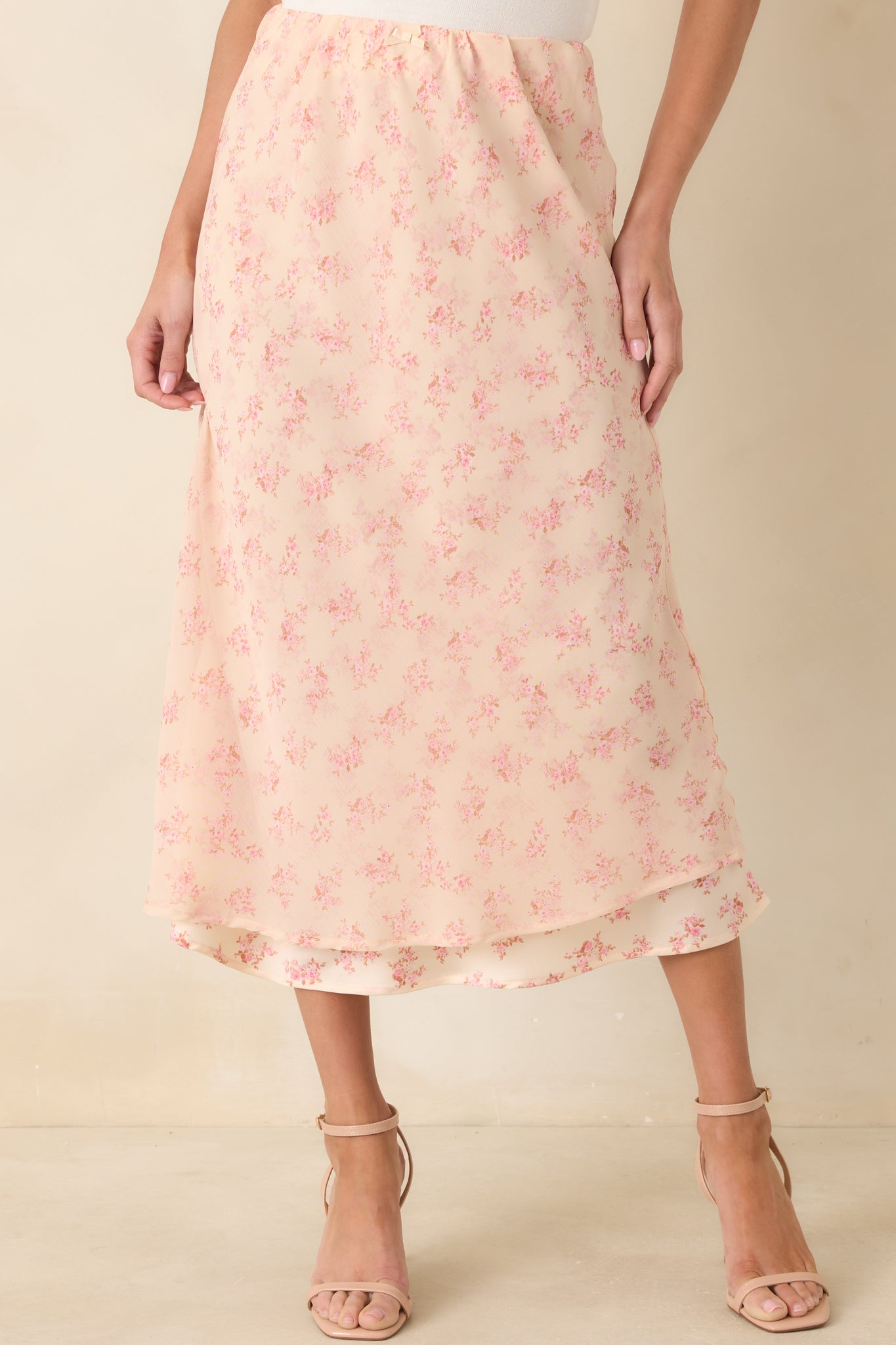 Closer look at the delicate floral print scattered across the airy chiffon, finished with subtle layered detailing.