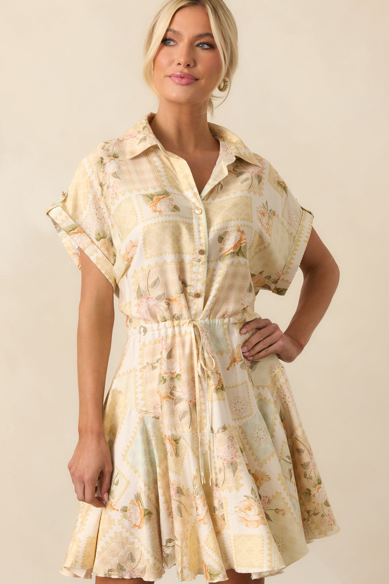 A closer view of the waist and skirt area, showing the self-tie drawstring and lightly flared hem of the yellow dress.