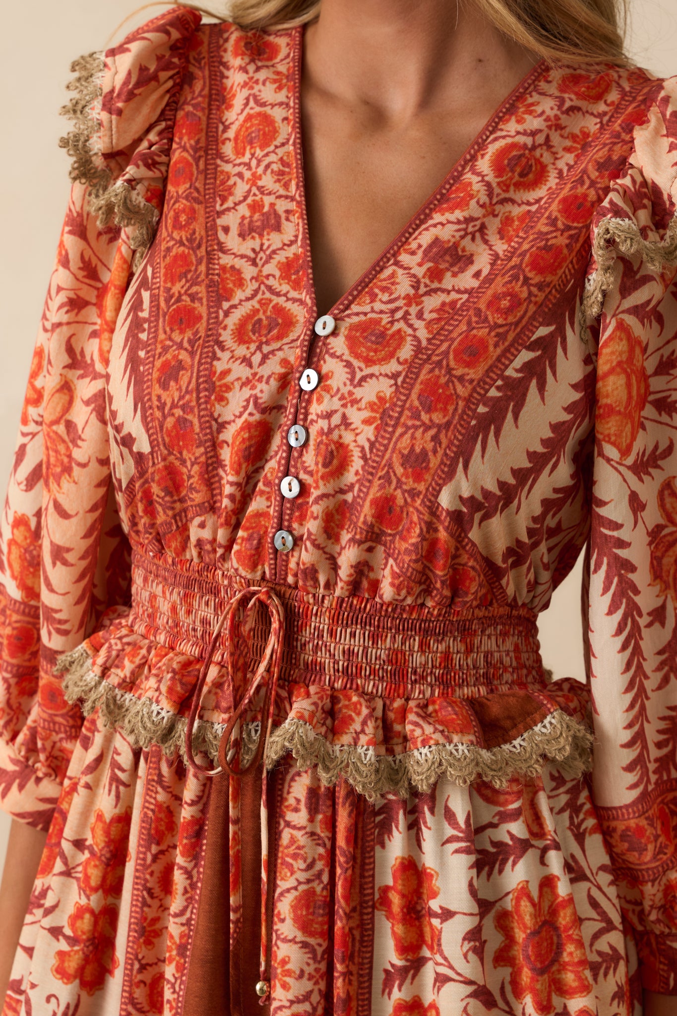 Close-up detail of the smocked waistband with drawstring self-tie and ruffle trim accents.