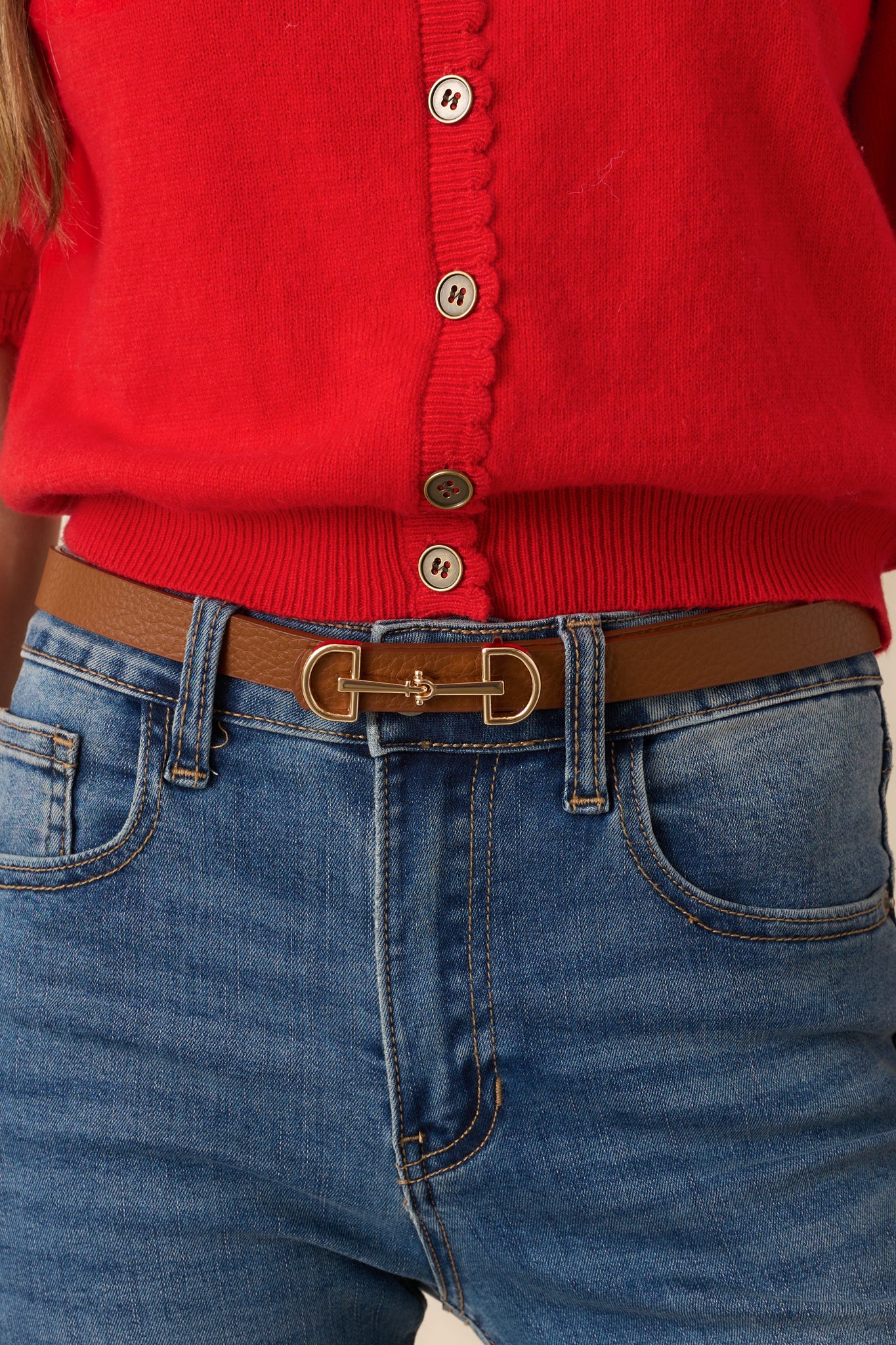 A close-up of the anchor buckle closure and gold hardware, emphasizing the textured surface of the faux leather.