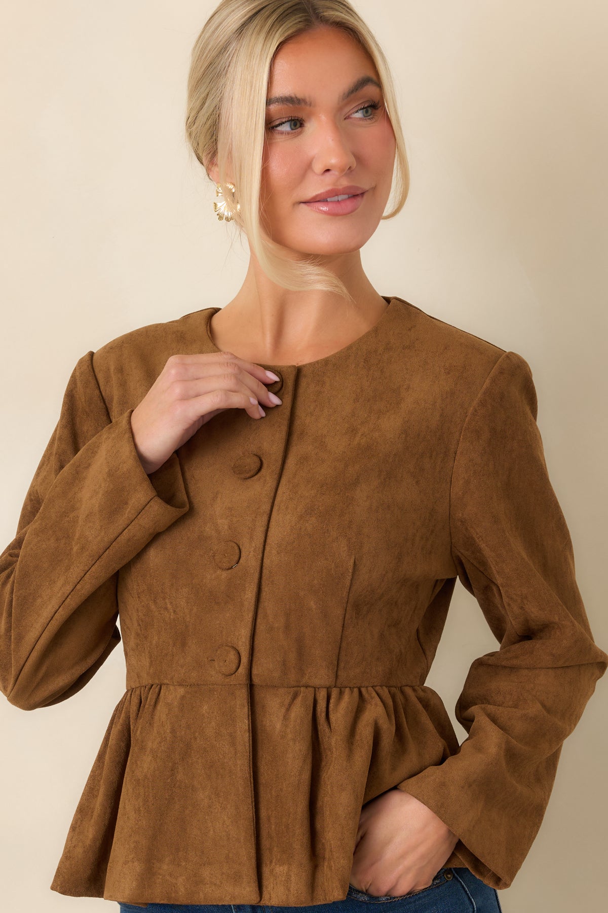 Button-front cognac top with subtle gathers at the shoulders and smooth long sleeves.