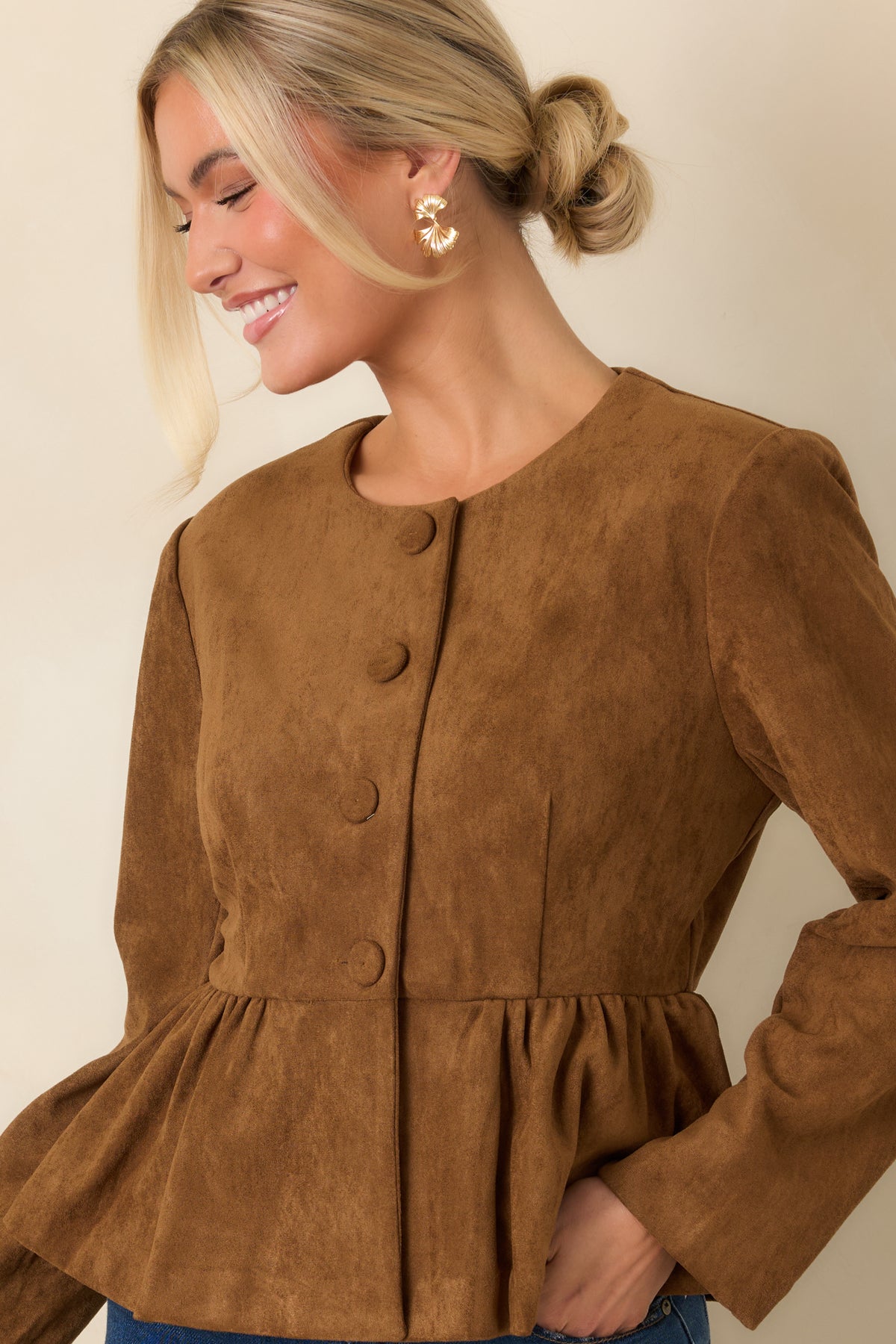 Cognac faux suede fabric highlights the fitted bodice and clean round neckline.