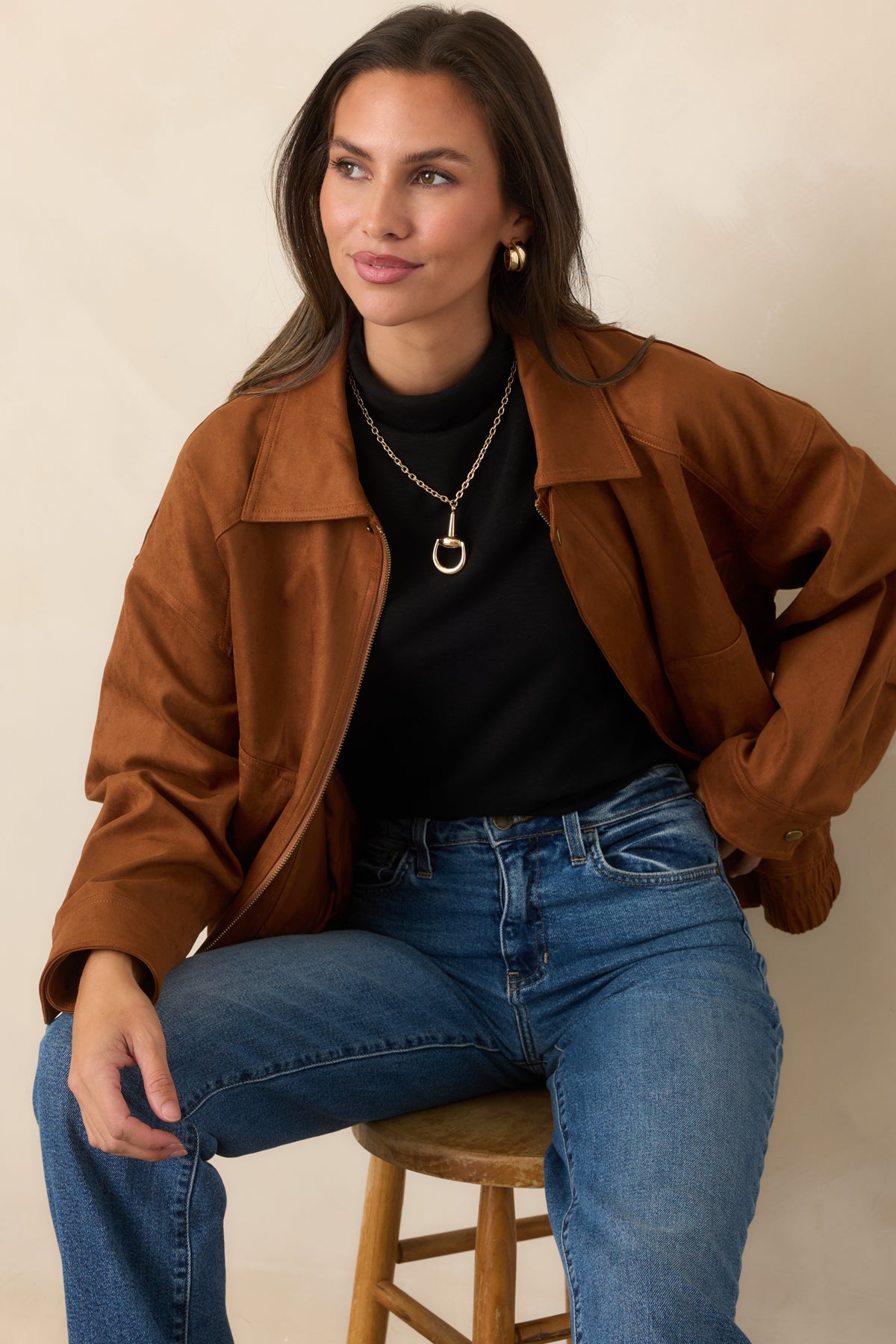 Soft cognac faux suede showcases the jacket's dropped shoulders and roomy long-sleeve construction.