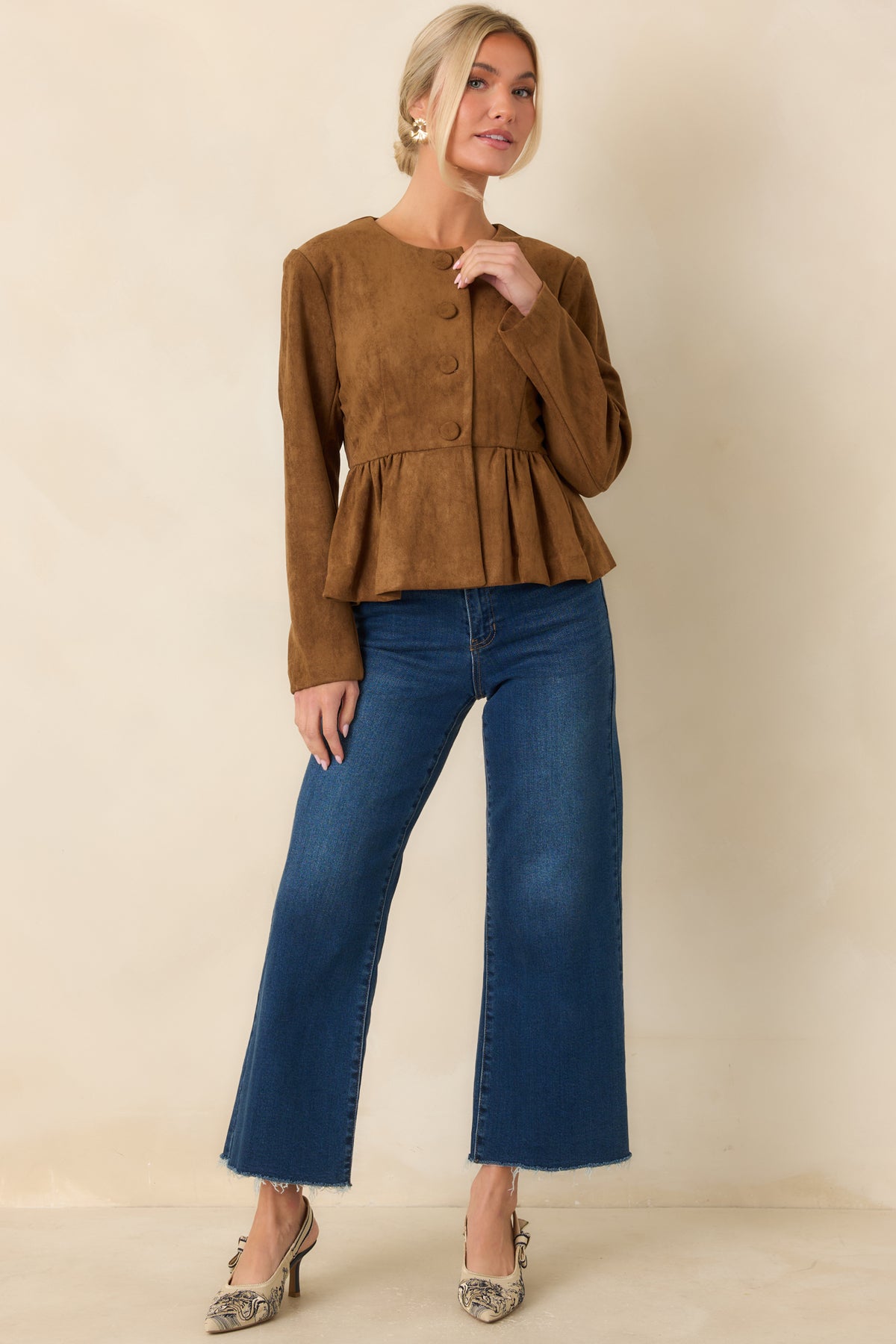 Cognac faux suede top with a fitted bodice, round neckline, and button-front closure.