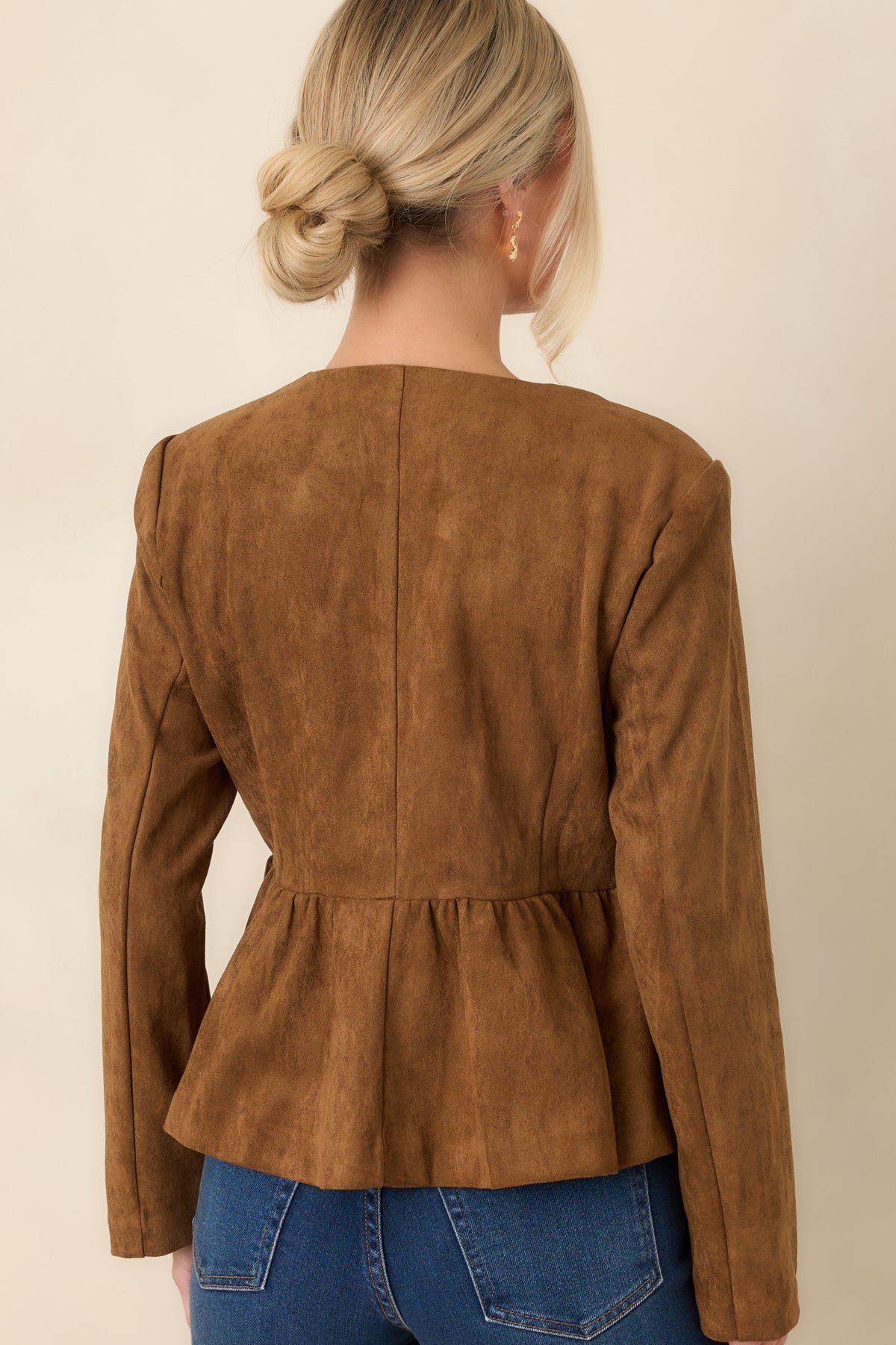 Rear of the cognac faux suede top showing the fitted waist and gently flared hem.