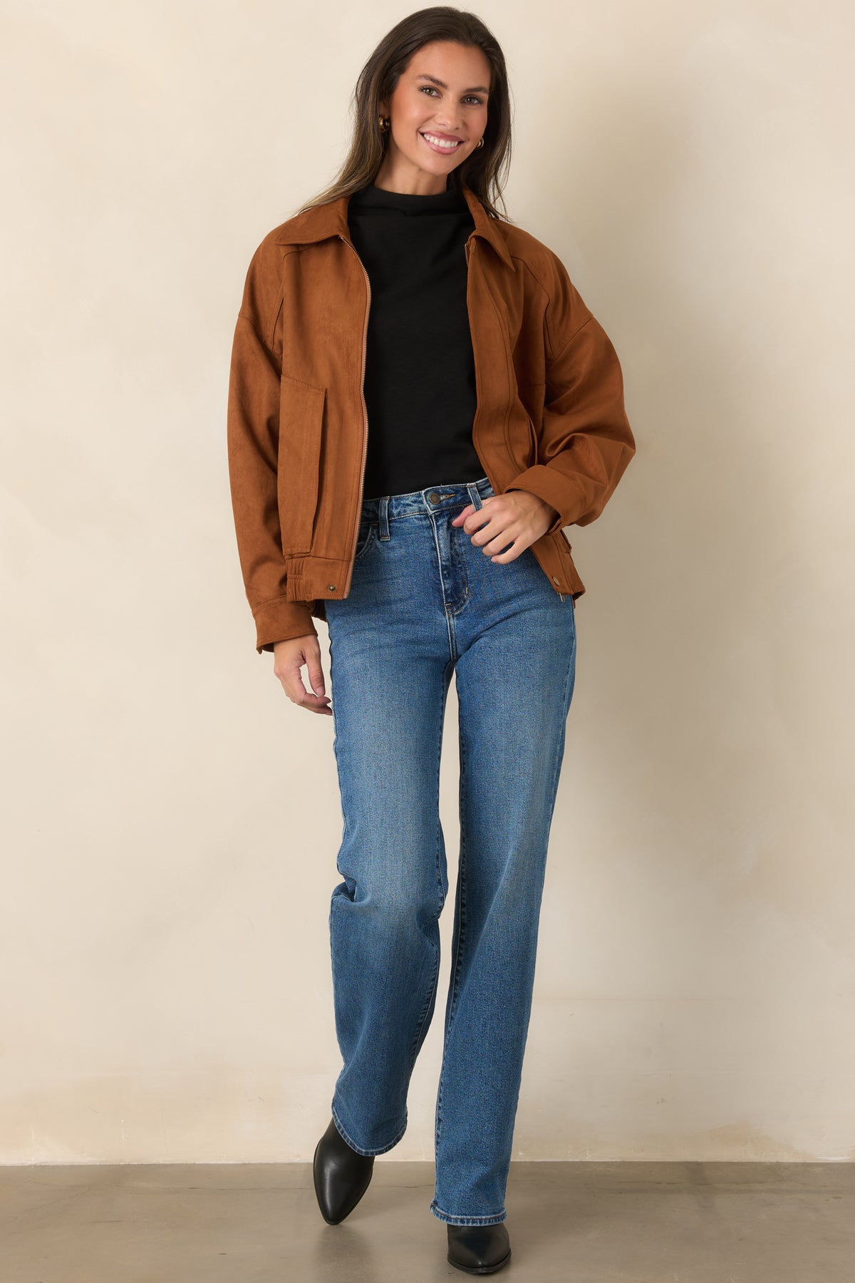 Warm cognac faux suede bomber jacket with a pointed collar, zip front, and relaxed dropped-shoulder silhouette.