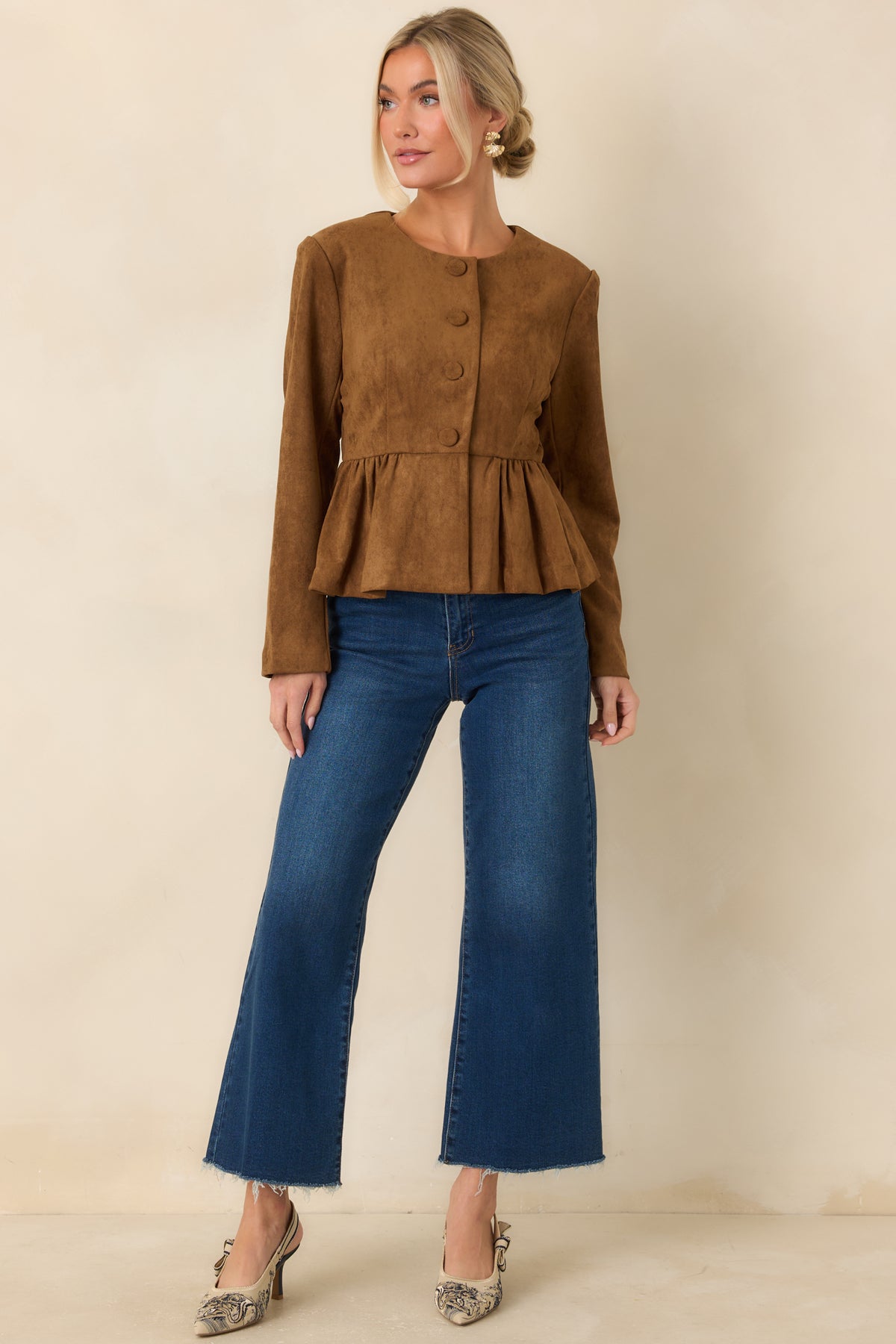Rich cognac top featuring long sleeves, subtle shoulder gathers, and a gently flared hem.