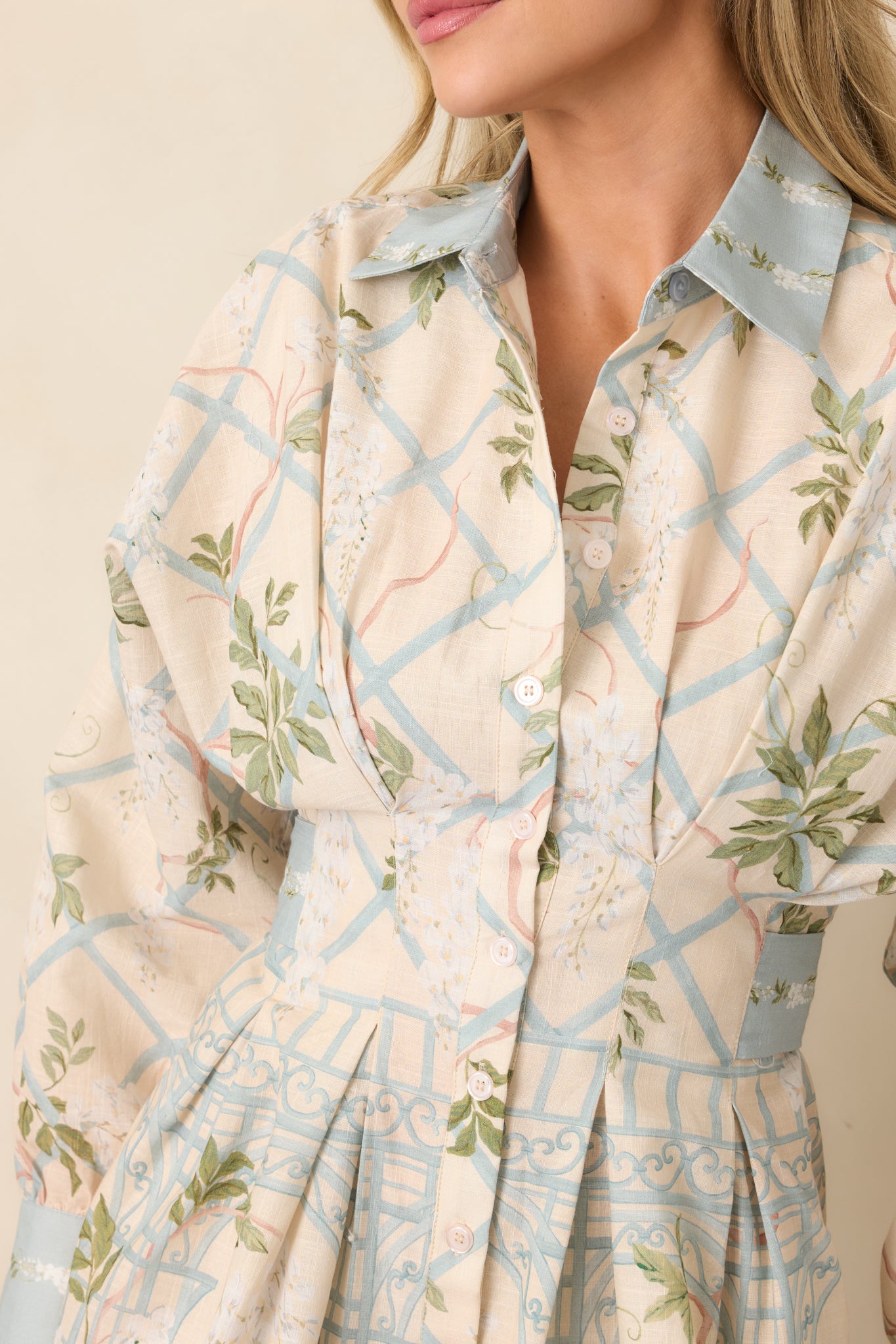 Close-up detail of the shirt dress highlighting the classic collar, button-front placket, and polished button cuff detailing.