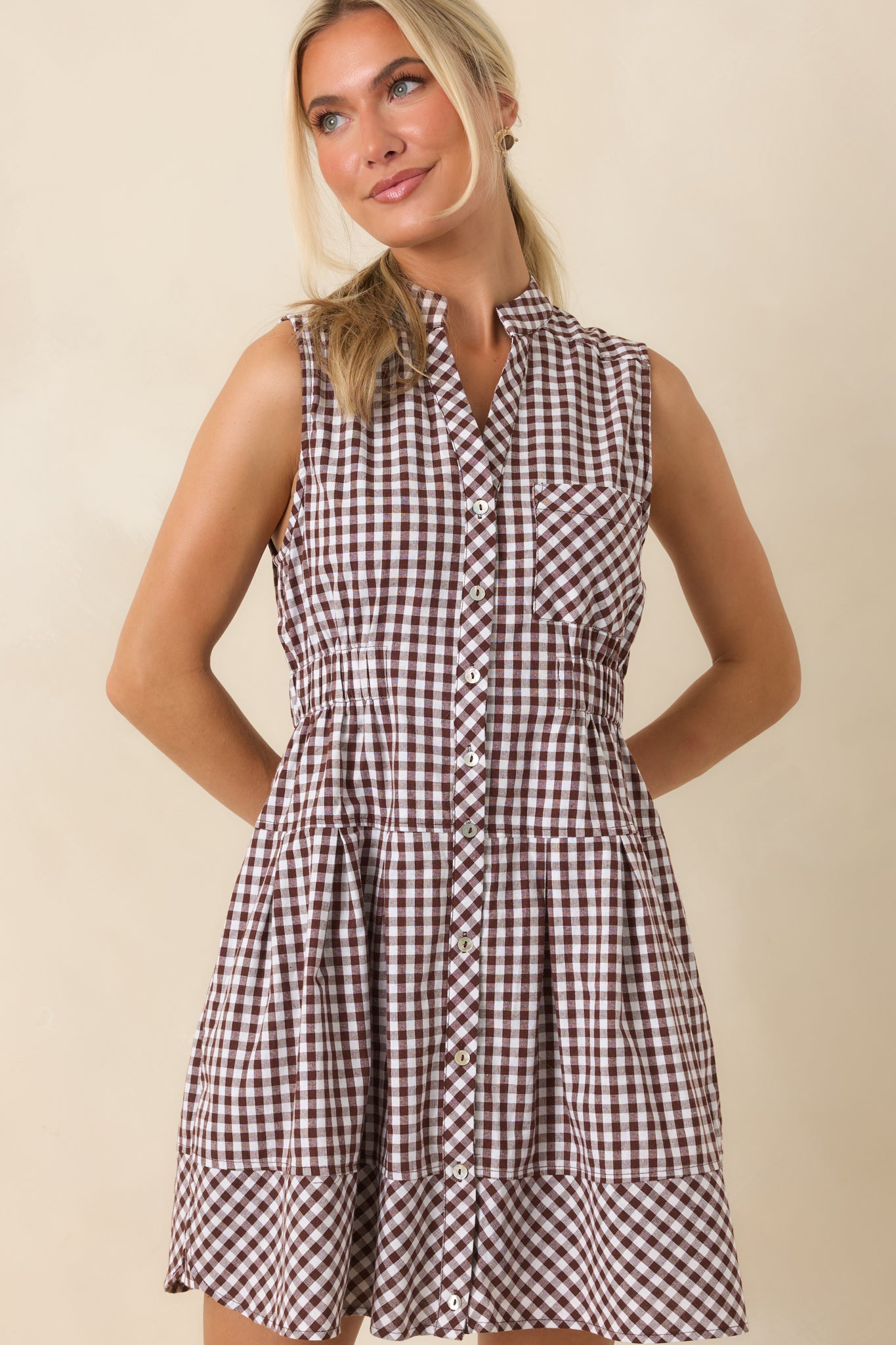 Collared neckline and button-front placket create a timeless look on this classic gingham mini dress.