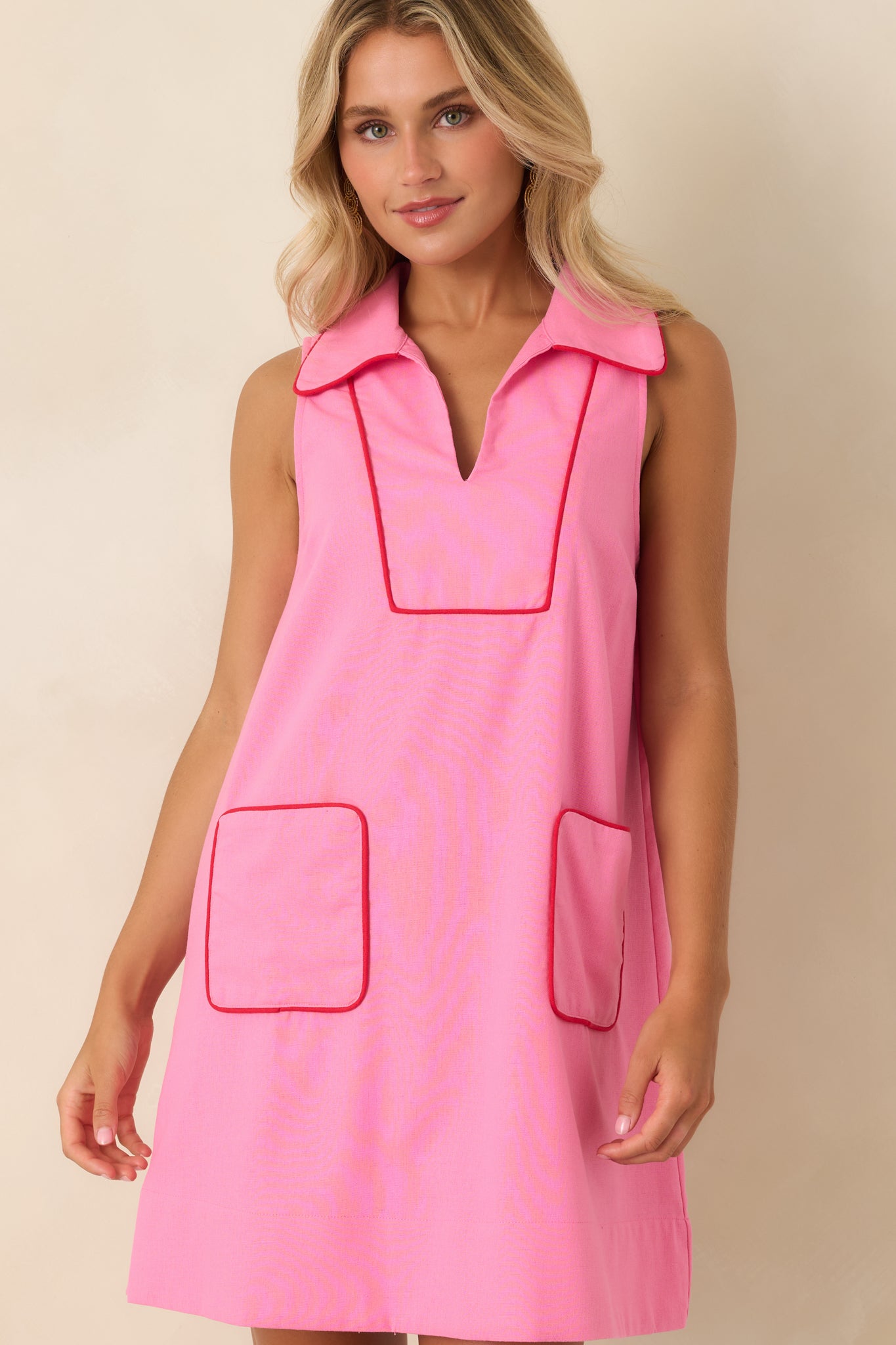 Collared linen blend dress highlighting the polished neckline, red piping accents, and lightweight woven fabric.