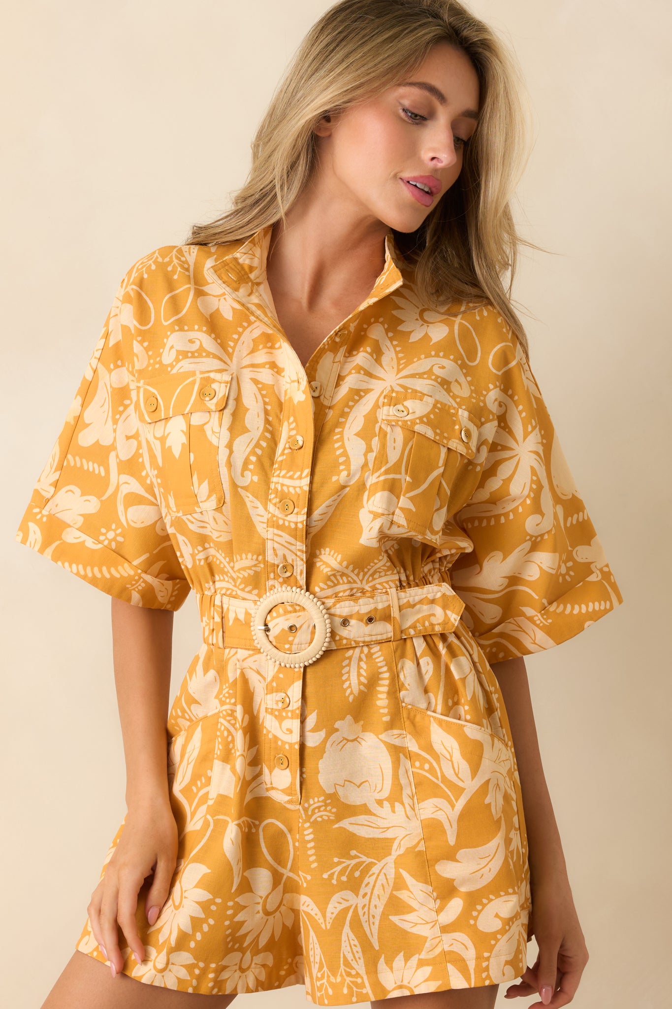 Detailed view of the collared neckline and button-front placket accented by the marigold and ivory botanical damask print.