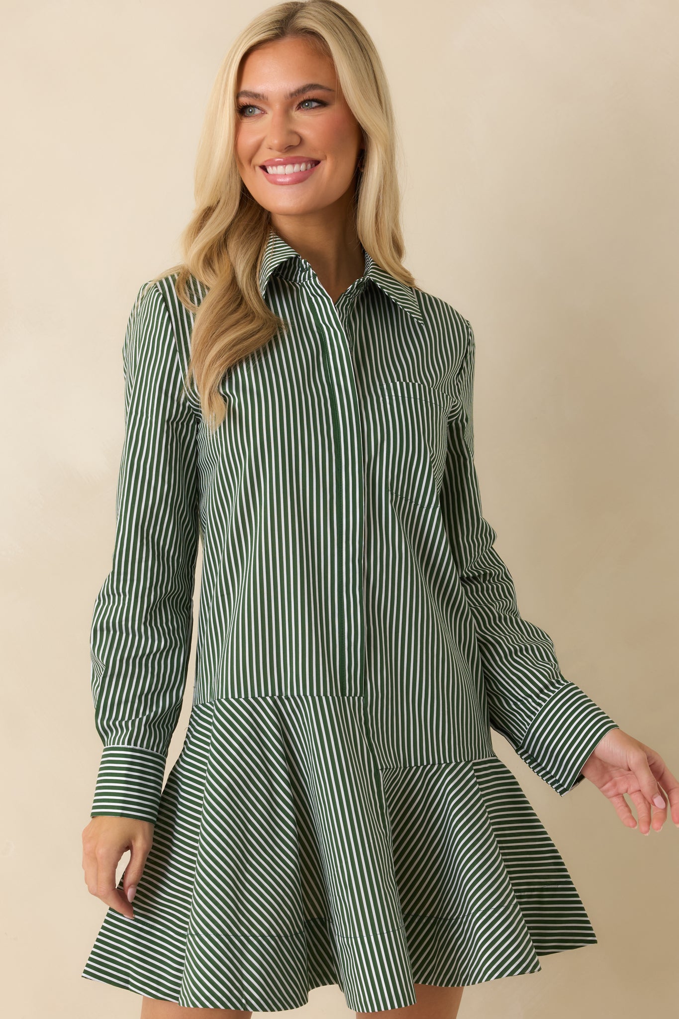 Collared neckline and placket detailing shown against the dark olive striped design.