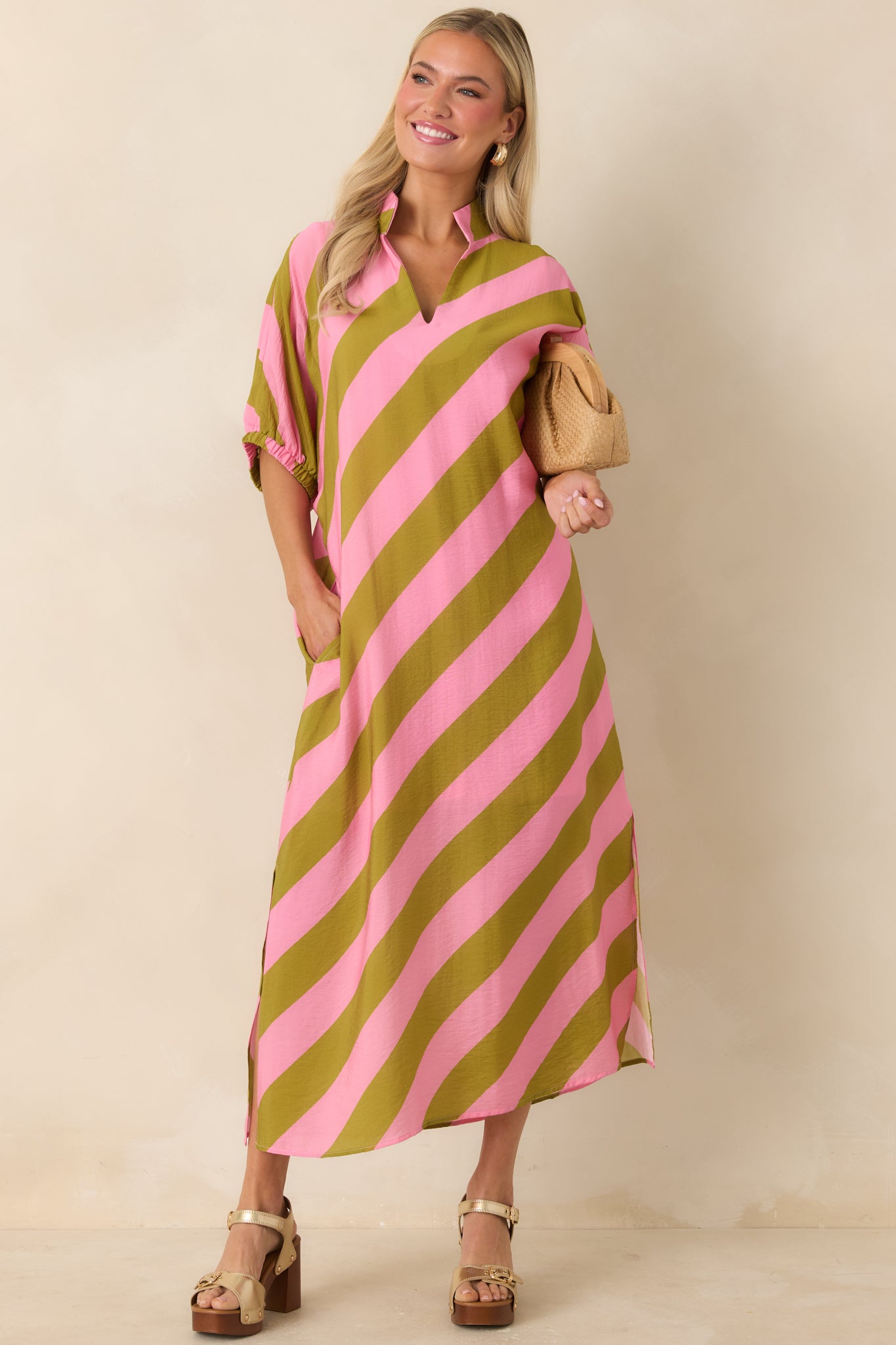 Collared striped maxi dress with relaxed fit, functional pockets, and soft drape.