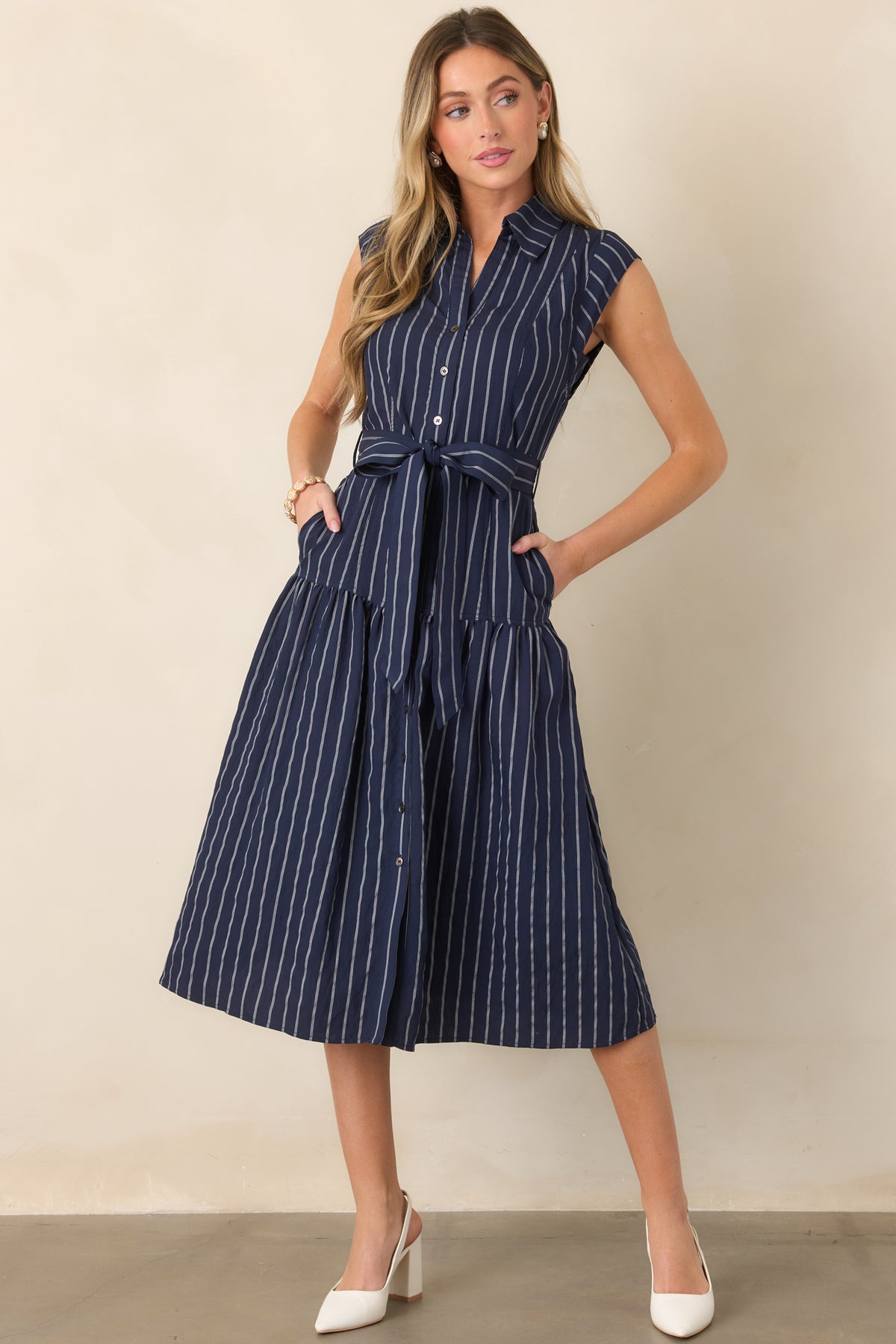 Classic collared midi dress with a vertical stripe pattern, removable waist belt, and relaxed full-skirt silhouette.