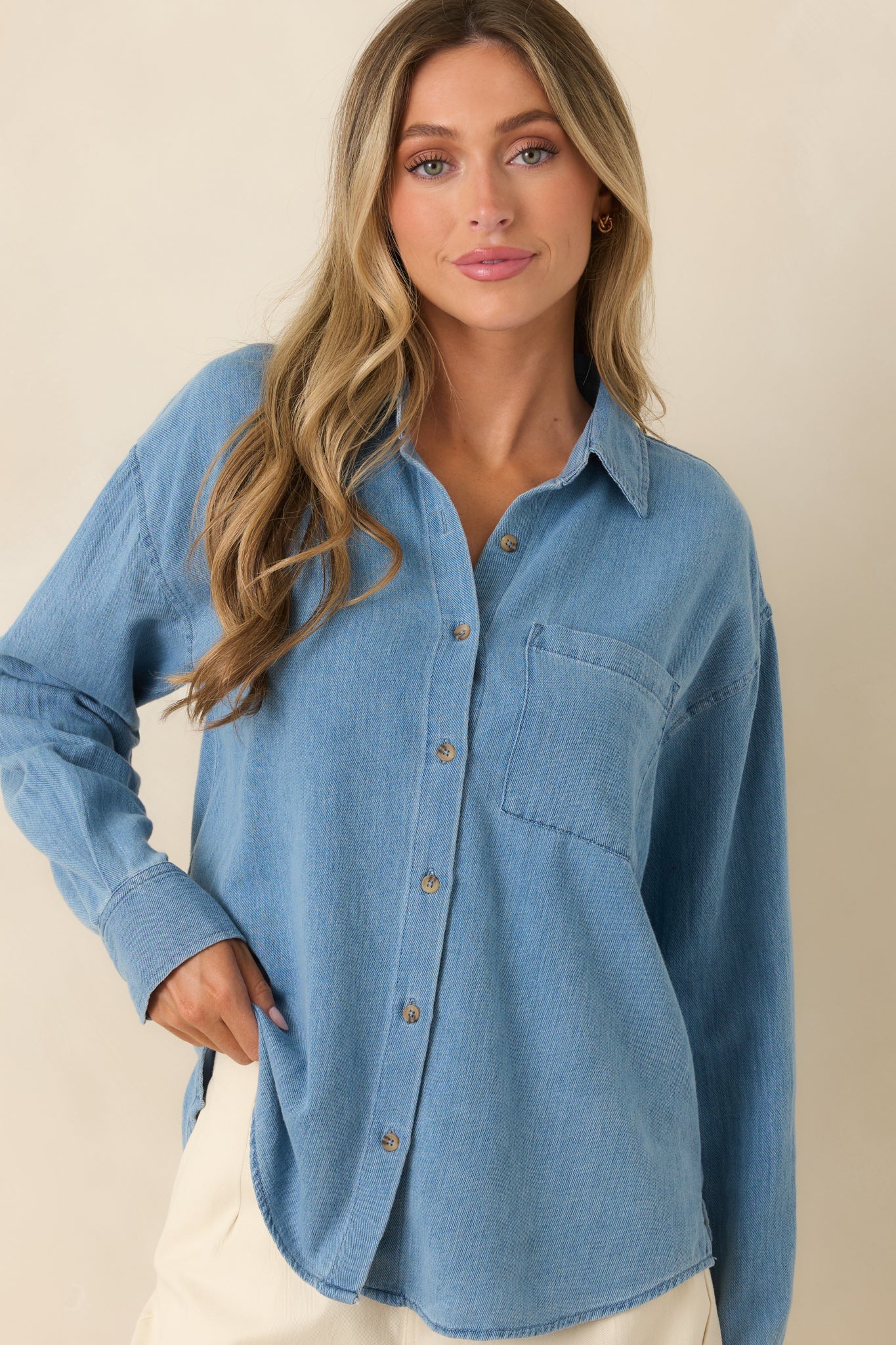 Detailed view of the collared neckline and functional button-front closure on the relaxed fit top.