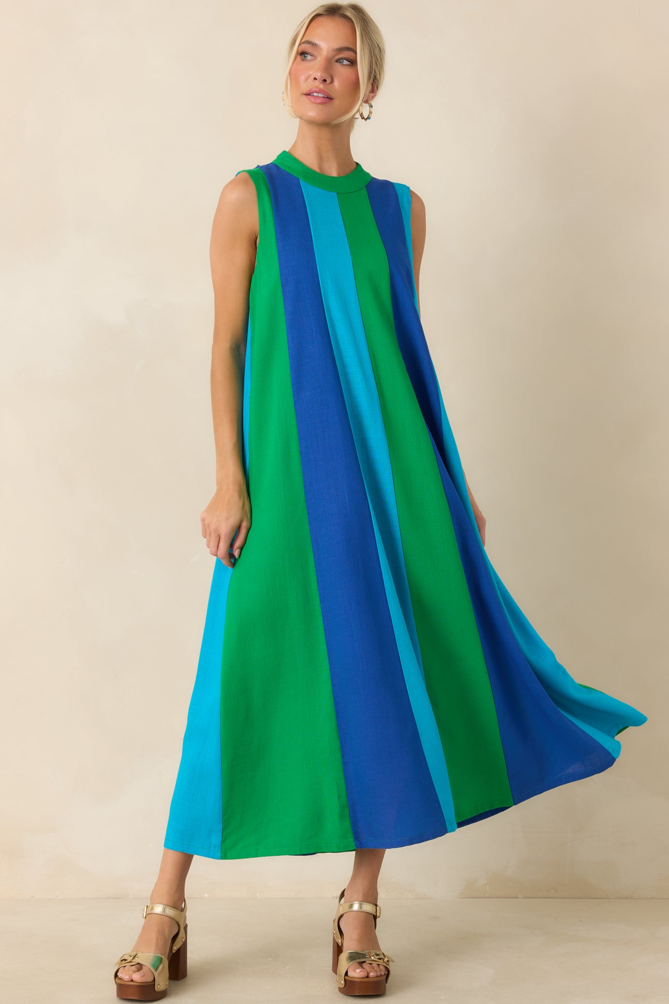 Sleeveless midi dress featuring bold vertical colorblock panels in green, turquoise, and cobalt blue with a flowing silhouette.