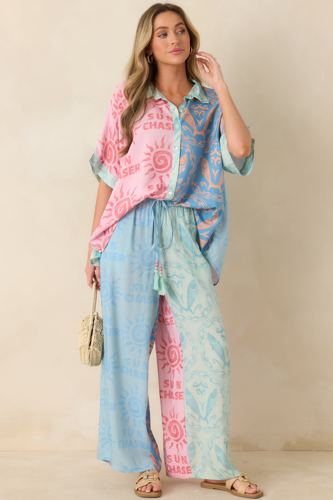 Colorblock wide leg pants featuring sun motifs, sea-inspired patterns, an elastic waistband, and lightweight viscose fabric.
