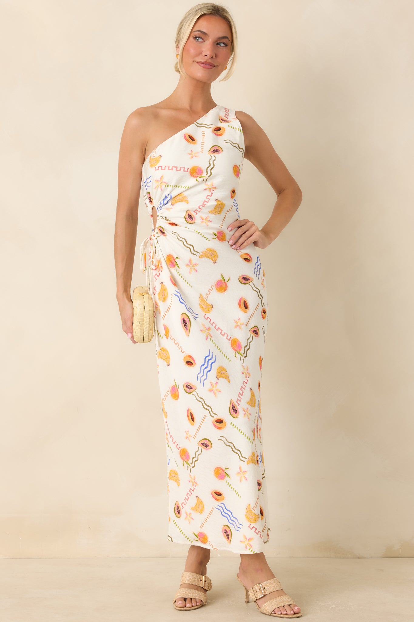 Colorful viscose maxi dress featuring a playful fruit print, one-shoulder neckline, and relaxed flowing silhouette.