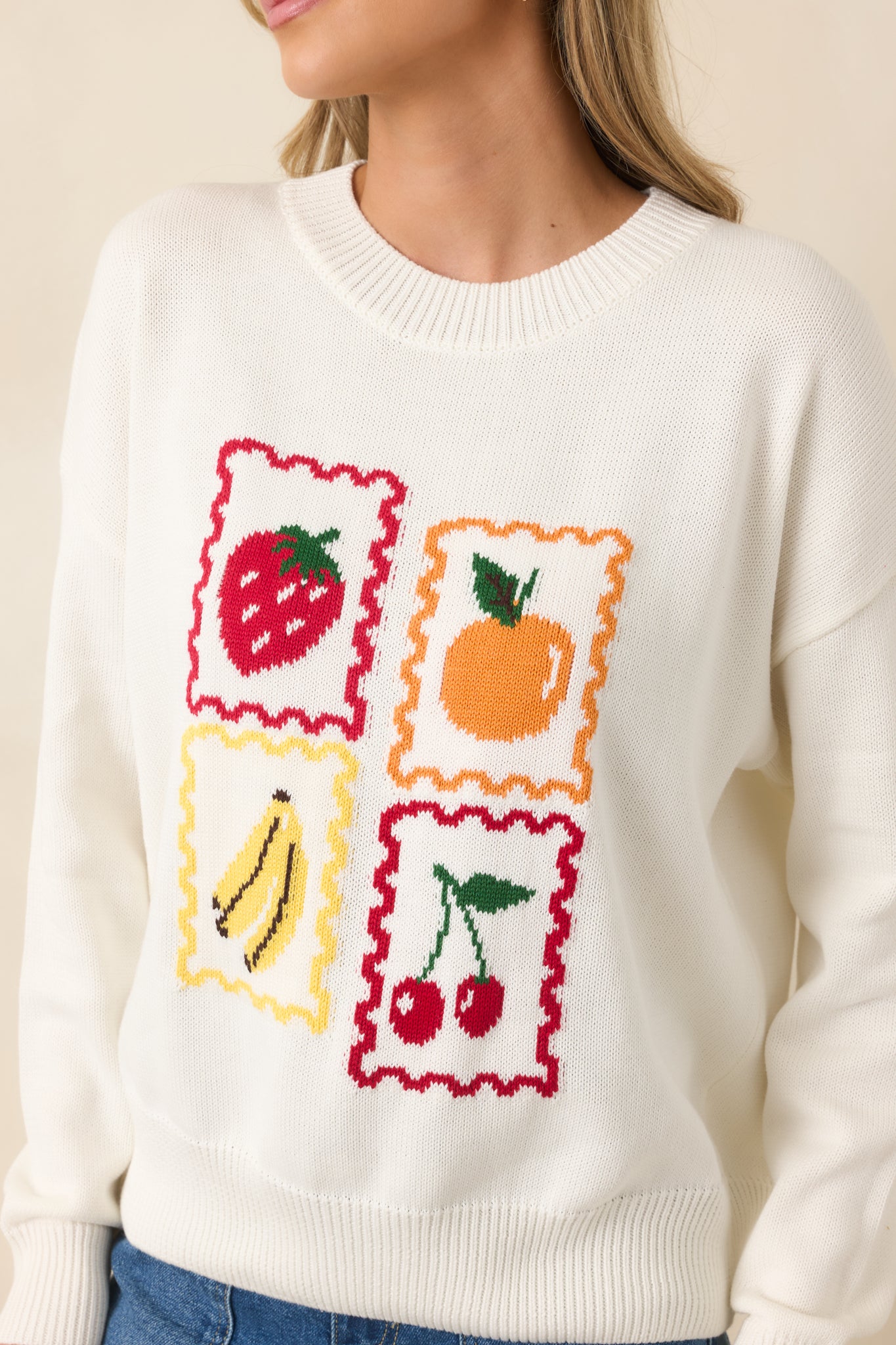 Colorful fruit stamp-style graphics on soft white knit fabric with scalloped framing.
