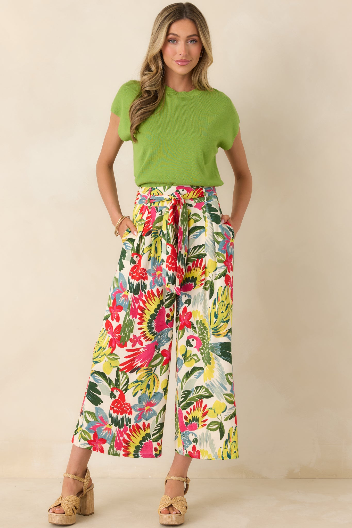 Colorful parrot and floral print pants with modern cropped length, defined waist, and relaxed wide-leg fit