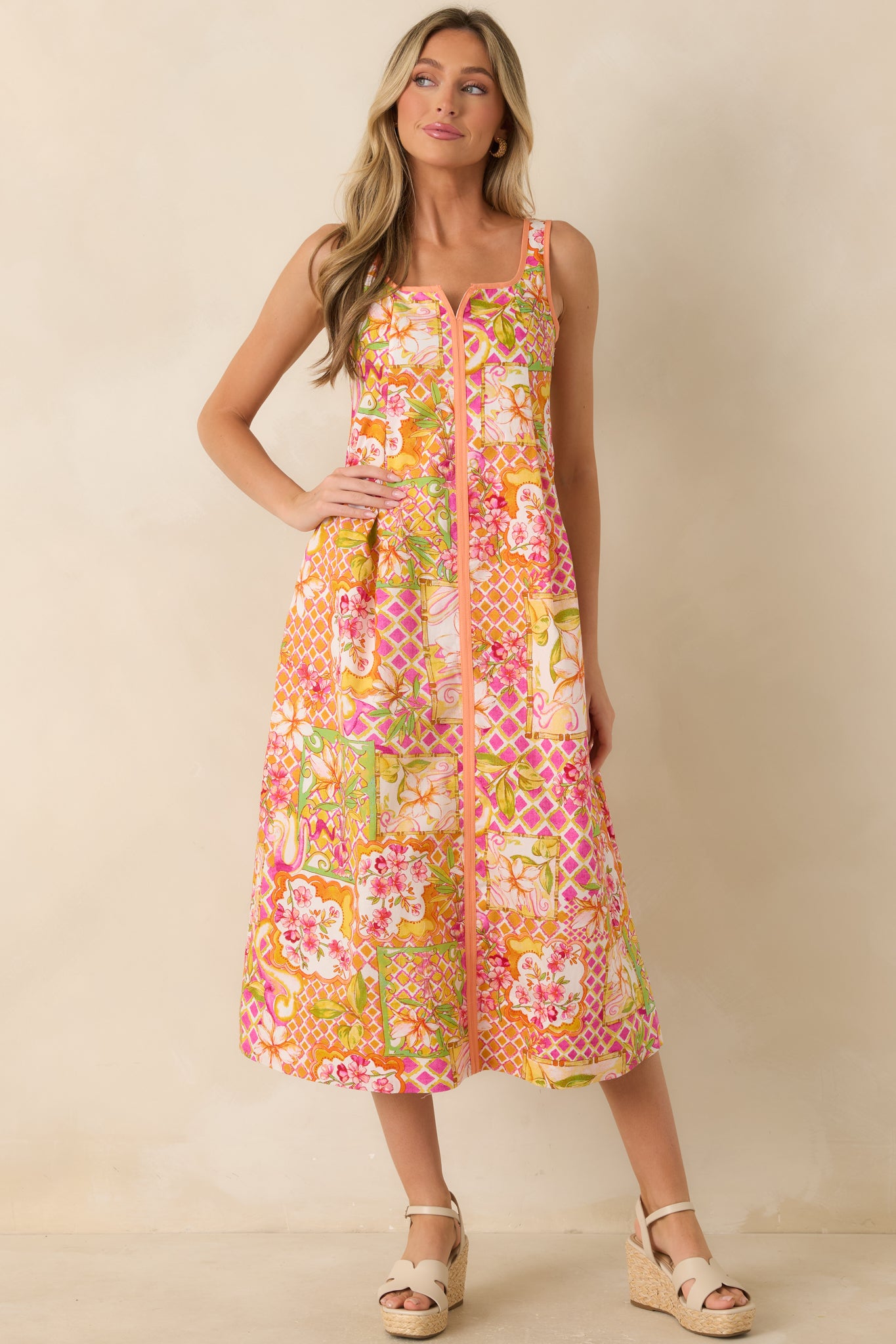 Colorful patchwork floral midi dress with contrast trim accents, a structured square neckline, and a flowing A-line skirt.